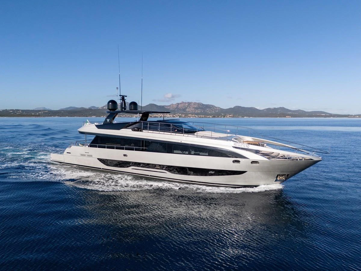 A sleek and modern yacht glides effortlessly across calm waters under a clear blue sky. aboard FILIPPETTI F100-03 Yacht for Sale