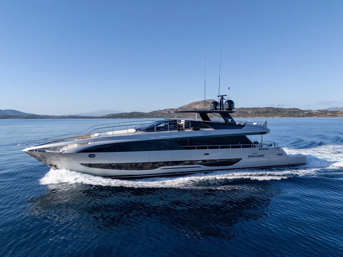 A sleek and modern yacht glides through calm waters with a scenic backdrop. aboard FILIPPETTI F100-03 Yacht for Sale
