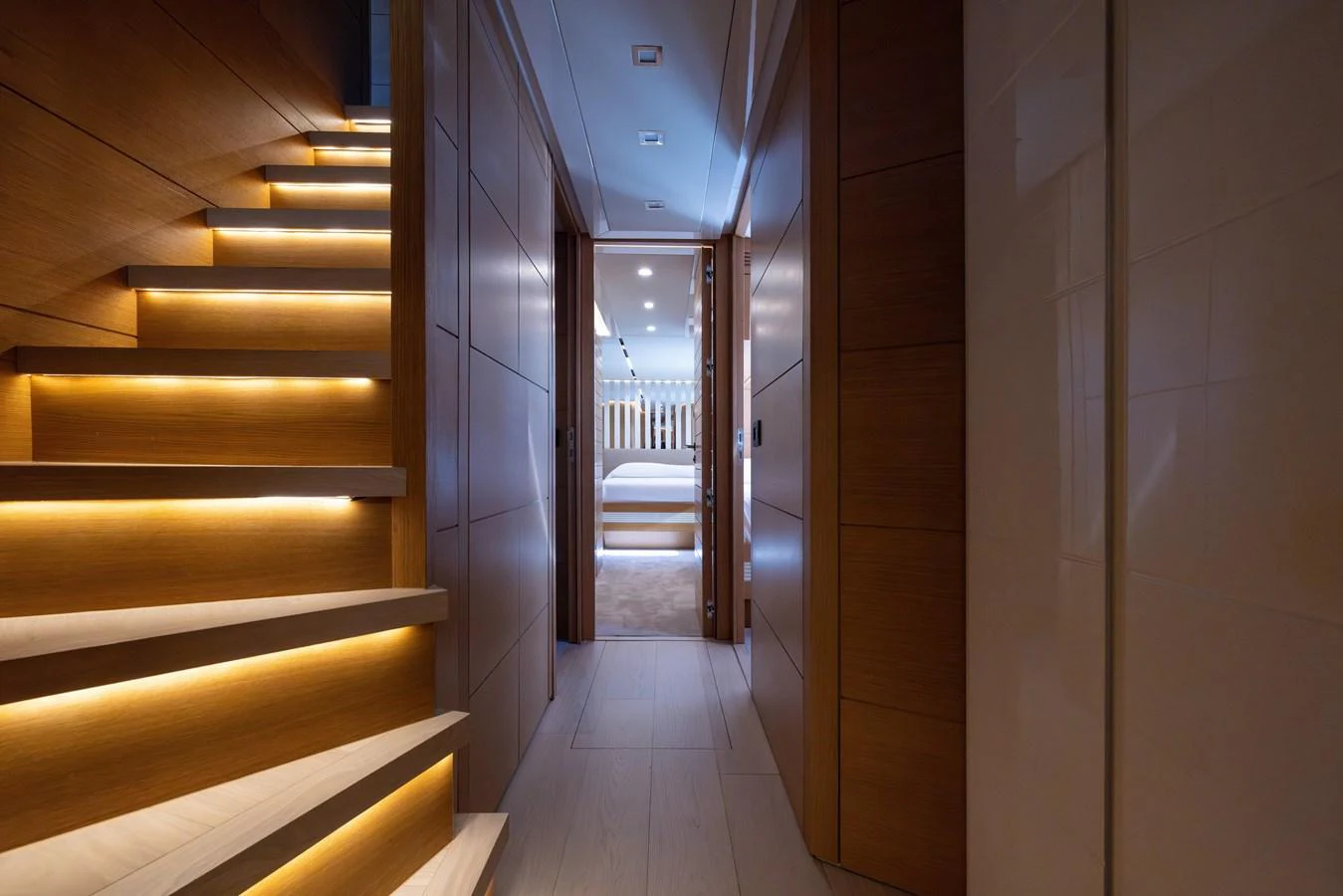 A luxurious hallway with ambient lighting leading to a cozy bedroom. aboard FILIPPETTI F100-03 Yacht for Sale