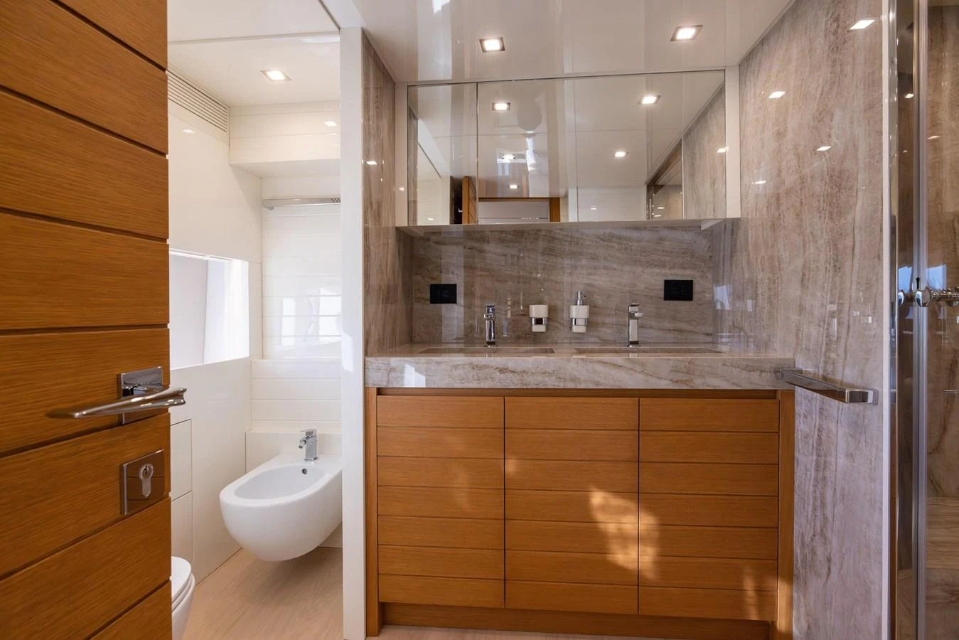 The yacht's bathroom features modern fixtures and a sleek design with wood and marble accents. aboard FILIPPETTI F100-03 Yacht for Sale