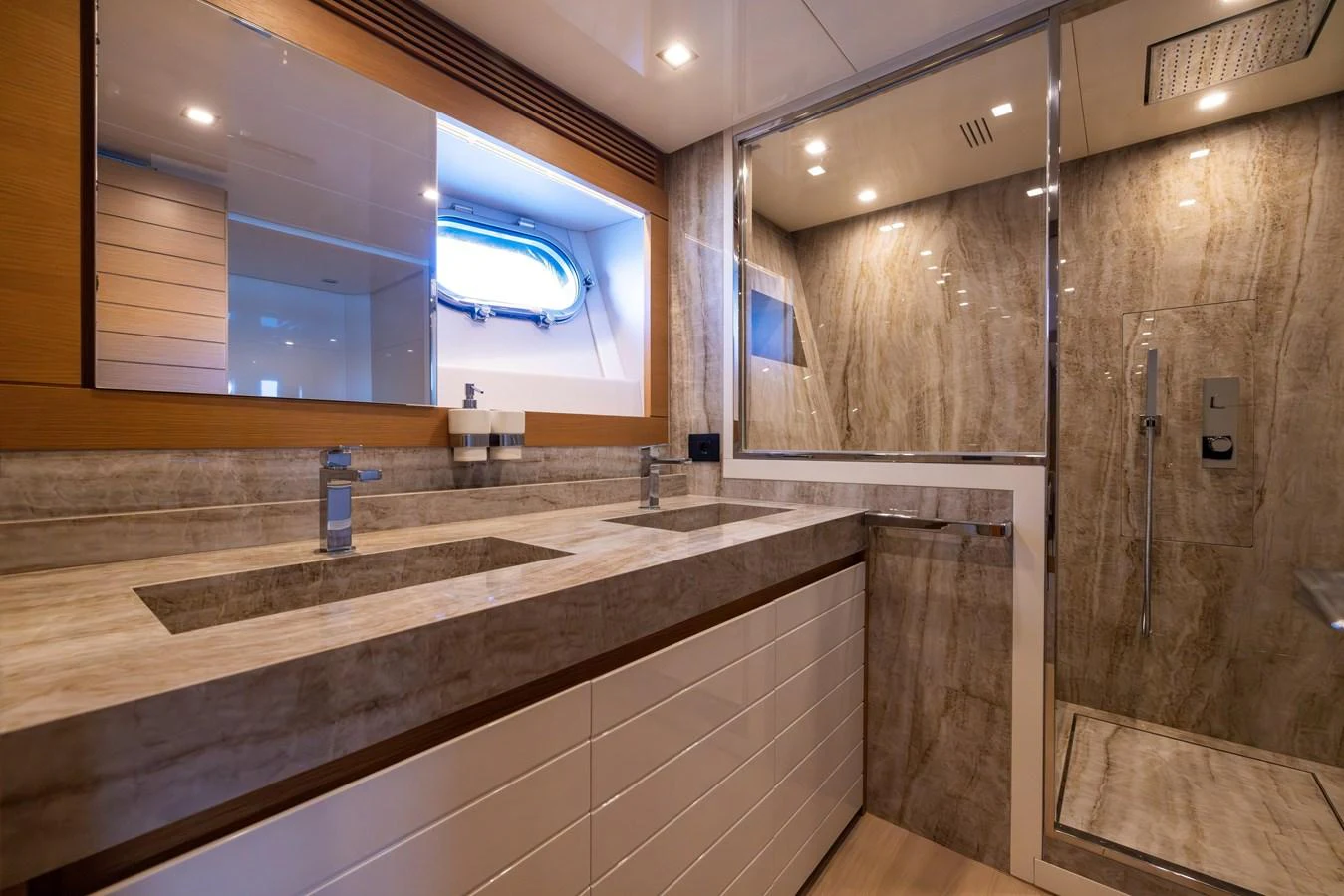 The yacht's bathroom features a luxurious design with dual sinks and a spacious shower area. aboard FILIPPETTI F100-03 Yacht for Sale