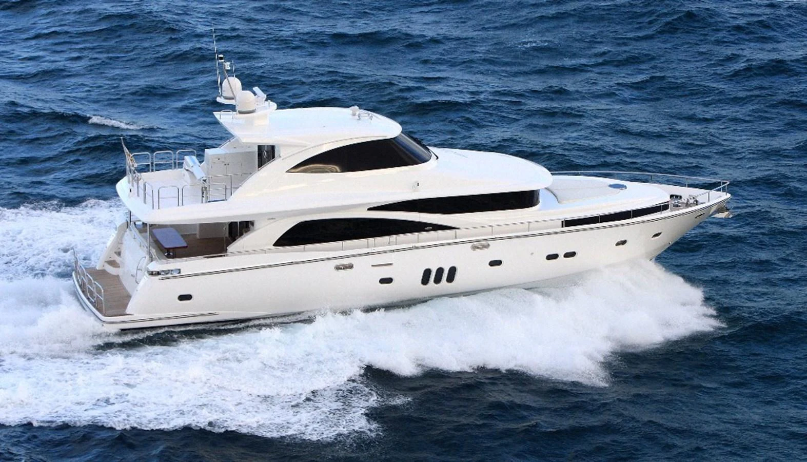 A sleek and modern yacht cruises swiftly through the open sea, showcasing its elegant design and powerful performance. aboard JOHNSON 83’ SKYLOUNGE W/FISHING COCKPIT Yacht for Sale