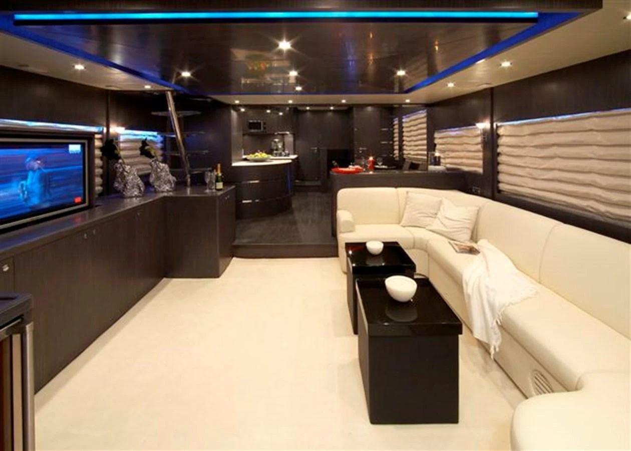The yacht's salon features a modern design with a spacious seating area and a sleek entertainment system. aboard JOHNSON 83’ SKYLOUNGE W/FISHING COCKPIT Yacht for Sale