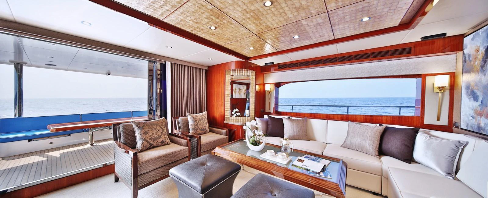 The salon offers a spacious and elegant living area with panoramic ocean views. aboard JOHNSON 83' FLYBRIDGE W/HYDRAULIC PLATFORM Yacht for Sale