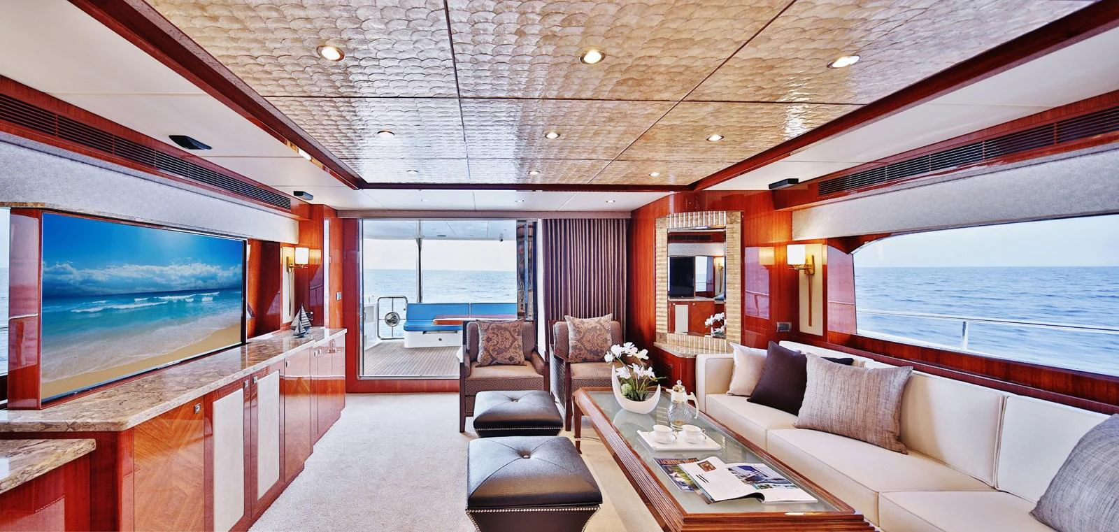 The salon offers a luxurious and spacious area with elegant furnishings and panoramic ocean views. aboard JOHNSON 83' FLYBRIDGE W/HYDRAULIC PLATFORM Yacht for Sale