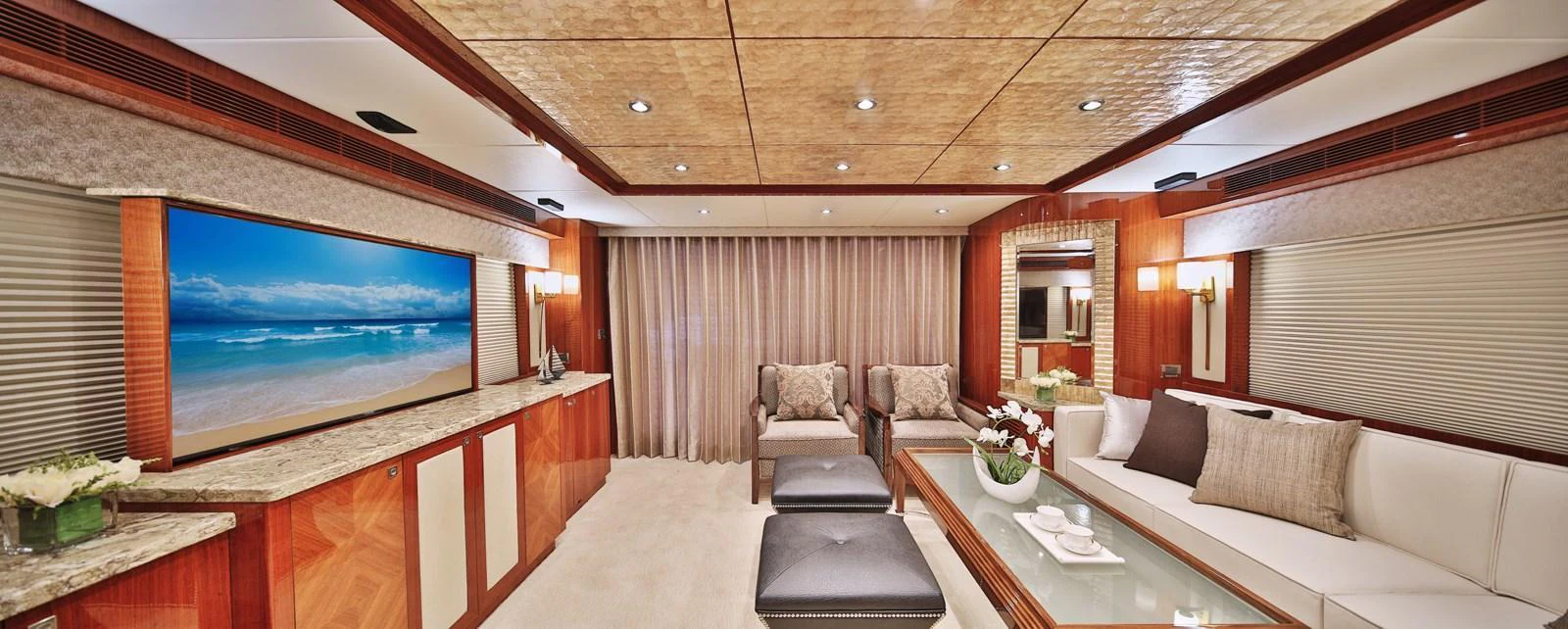 The salon features luxurious seating, a large flat-screen TV, and elegant decor. aboard JOHNSON 83' FLYBRIDGE W/HYDRAULIC PLATFORM Yacht for Sale