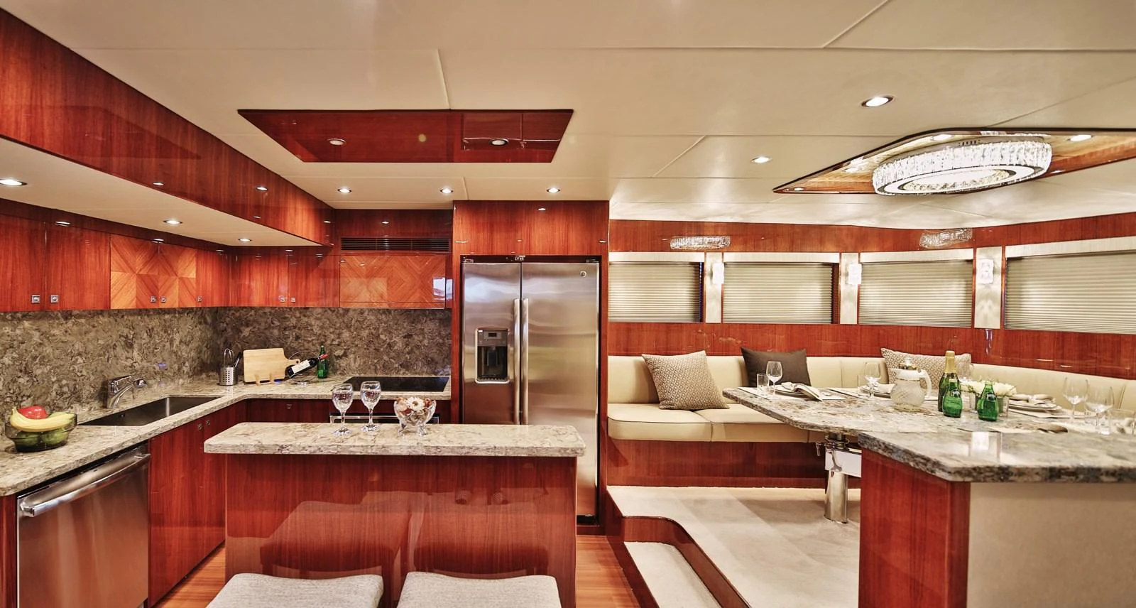 The yacht's galley features elegant wood finishes and modern appliances, creating a luxurious and functional space. aboard JOHNSON 83' FLYBRIDGE W/HYDRAULIC PLATFORM Yacht for Sale