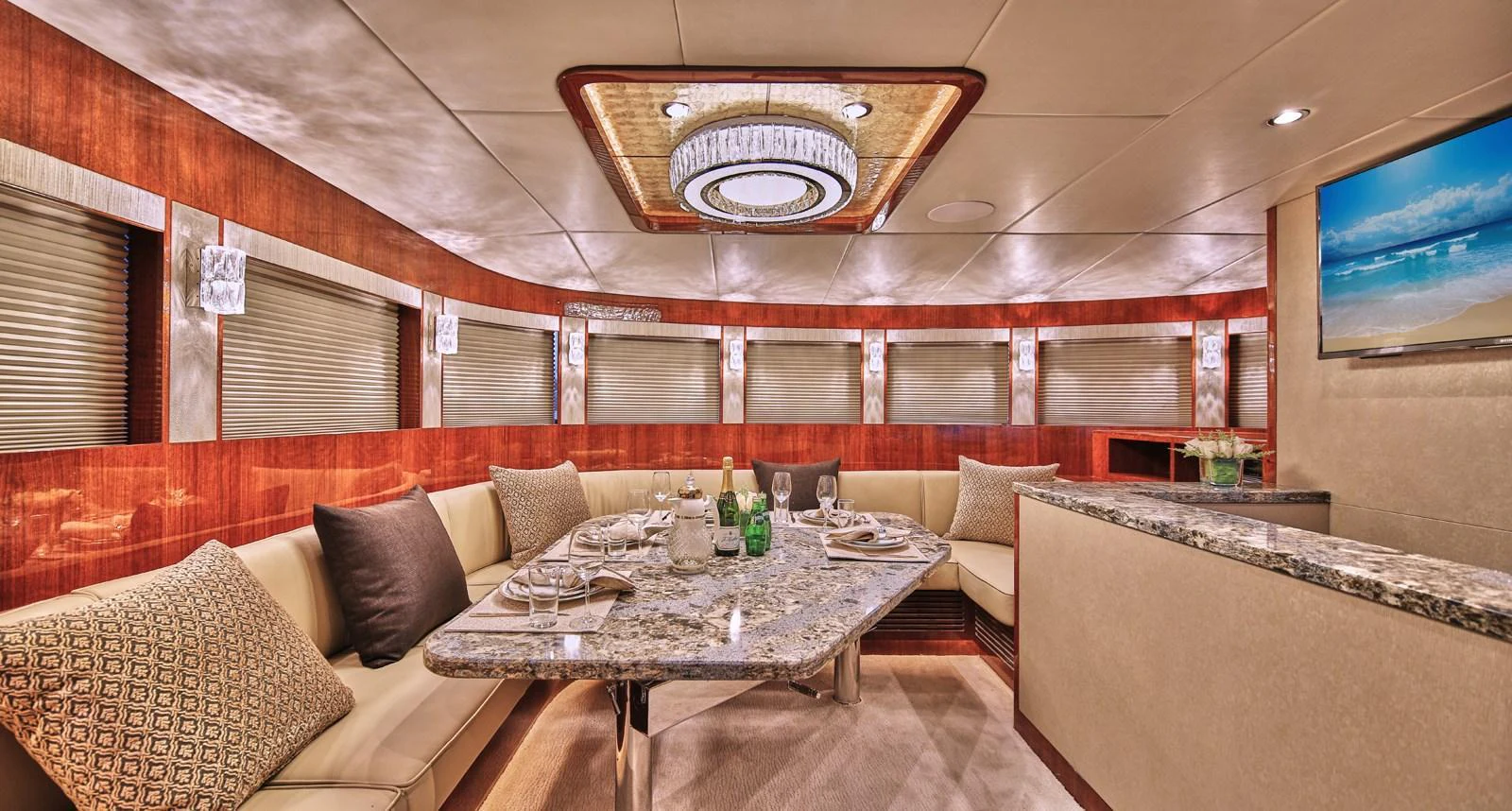 The yacht's dining area features a luxurious setting with a granite table and plush seating. aboard JOHNSON 83' FLYBRIDGE W/HYDRAULIC PLATFORM Yacht for Sale