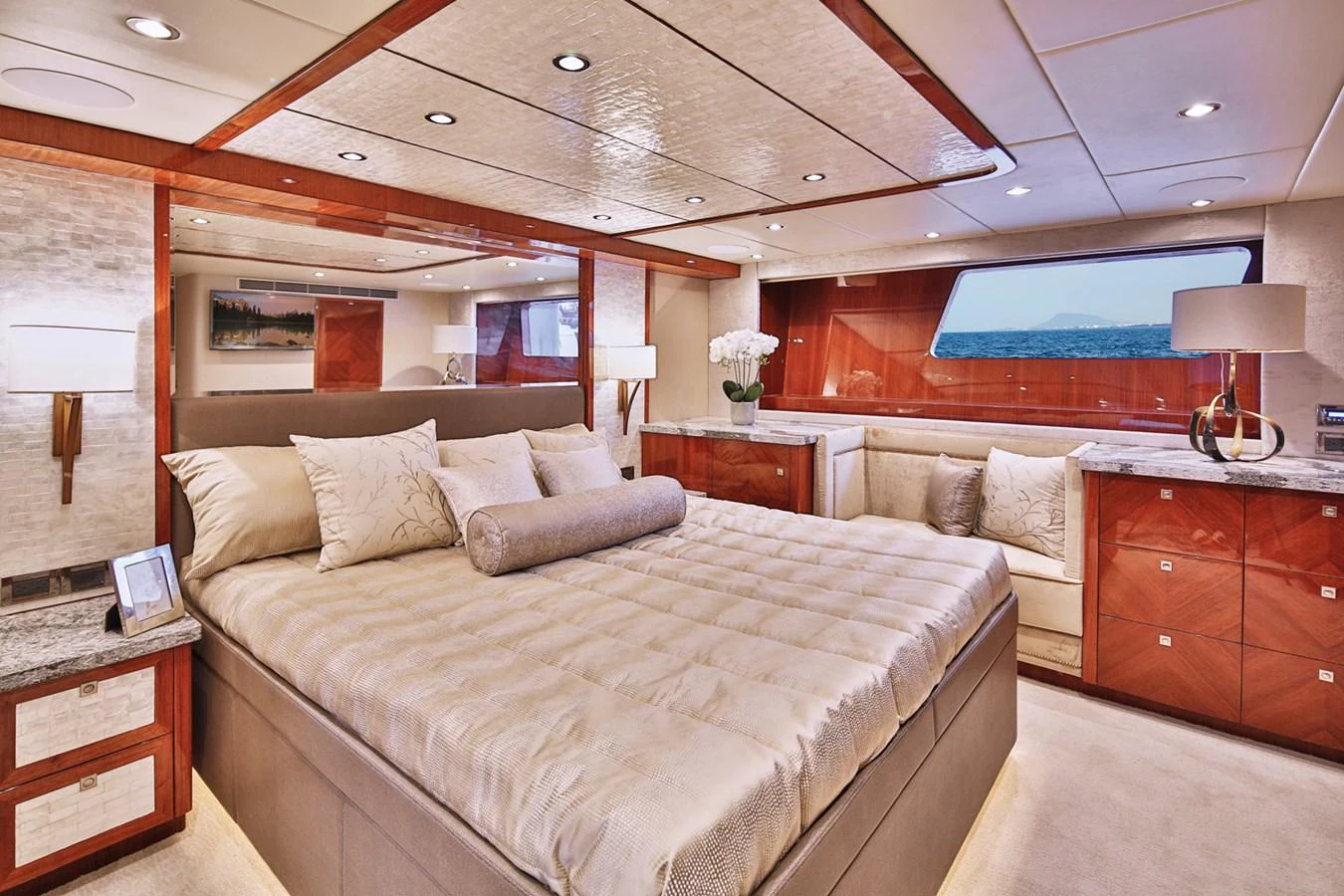 The master stateroom offers a luxurious and spacious retreat with elegant wood finishes and a large bed. aboard JOHNSON 83' FLYBRIDGE W/HYDRAULIC PLATFORM Yacht for Sale
