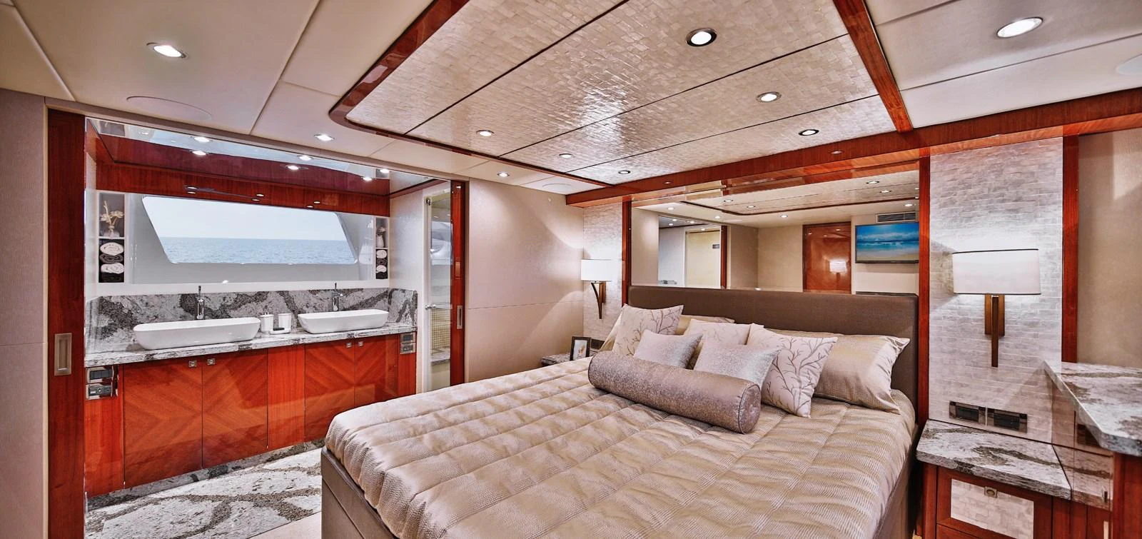 The master stateroom features luxurious bedding, elegant wood finishes, and a spacious layout. aboard JOHNSON 83' FLYBRIDGE W/HYDRAULIC PLATFORM Yacht for Sale
