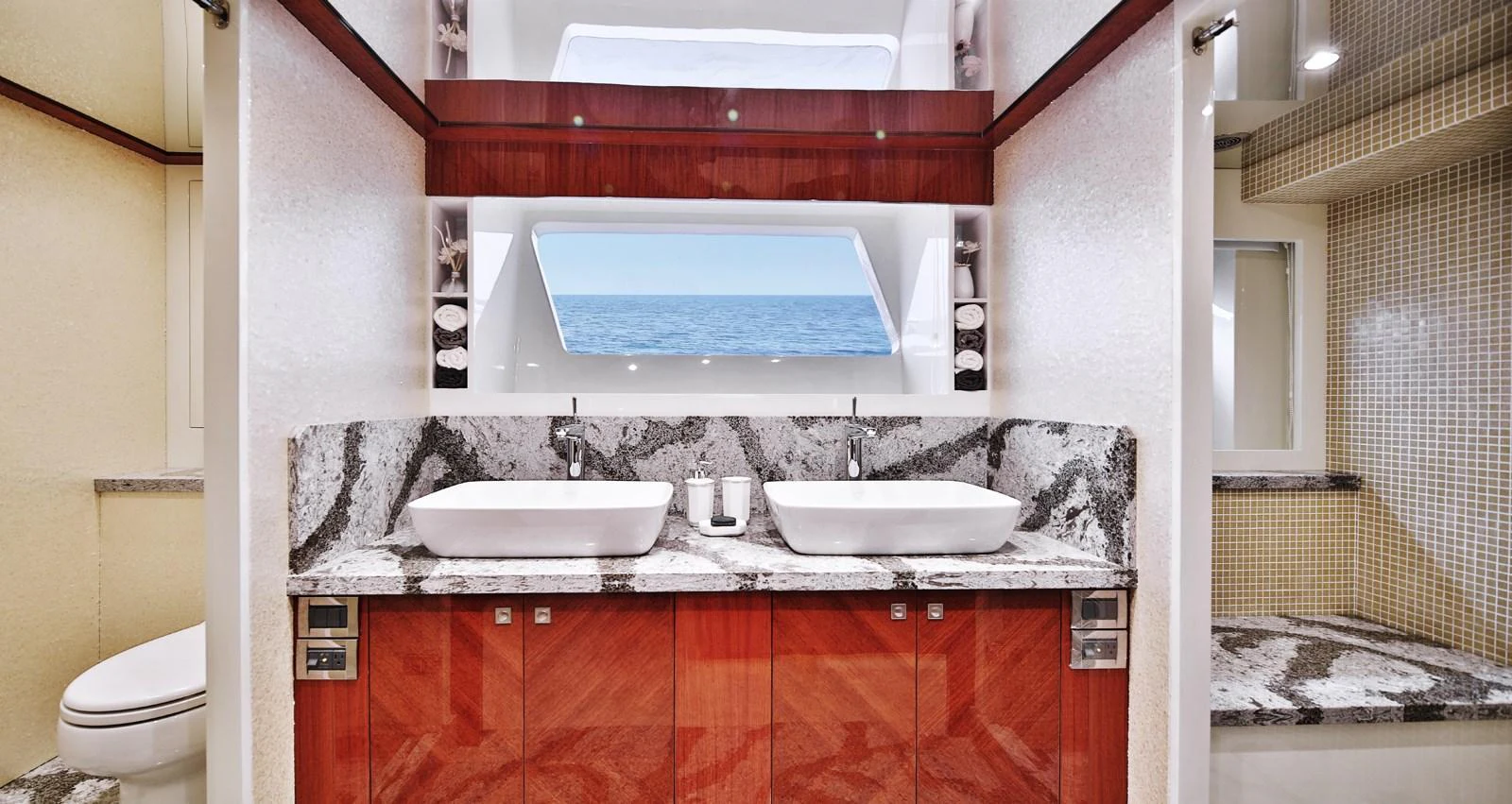The yacht's bathroom features a luxurious double sink setup with a large mirror and elegant marble countertops. aboard JOHNSON 83' FLYBRIDGE W/HYDRAULIC PLATFORM Yacht for Sale