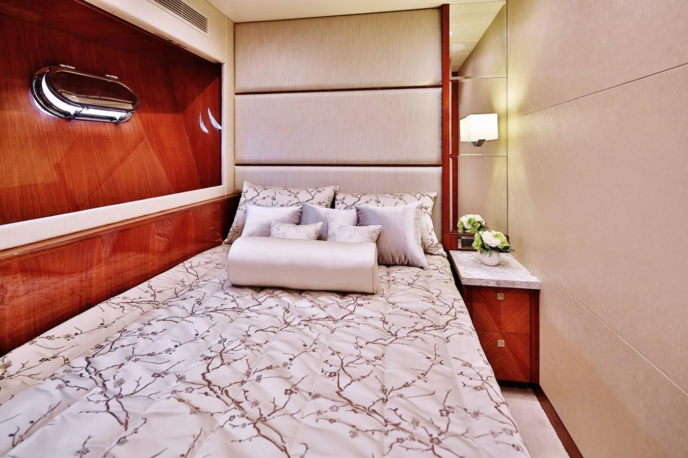 The stateroom features a plush bed with elegant bedding and warm wood accents, creating a cozy and inviting atmosphere. aboard JOHNSON 83' FLYBRIDGE W/HYDRAULIC PLATFORM Yacht for Sale