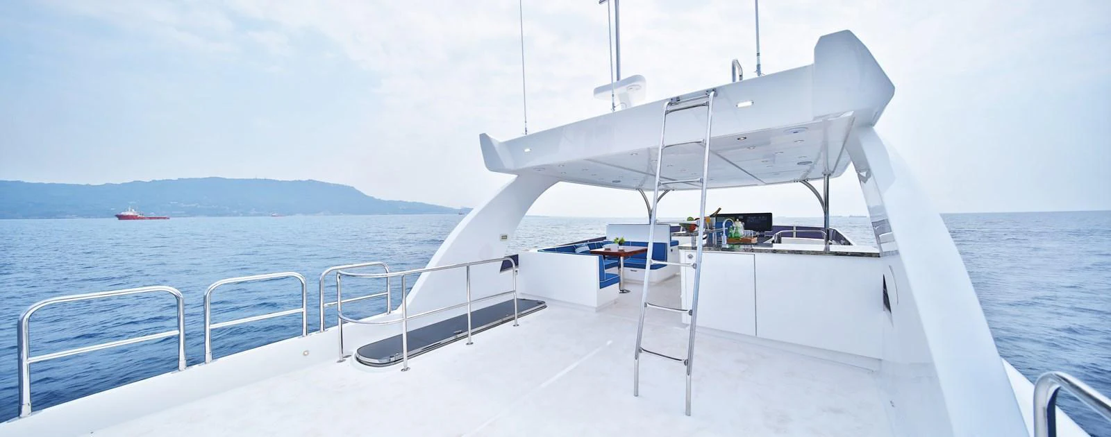 The flybridge offers an expansive and open space with a sleek design, perfect for enjoying panoramic ocean views. aboard JOHNSON 83' FLYBRIDGE W/HYDRAULIC PLATFORM Yacht for Sale