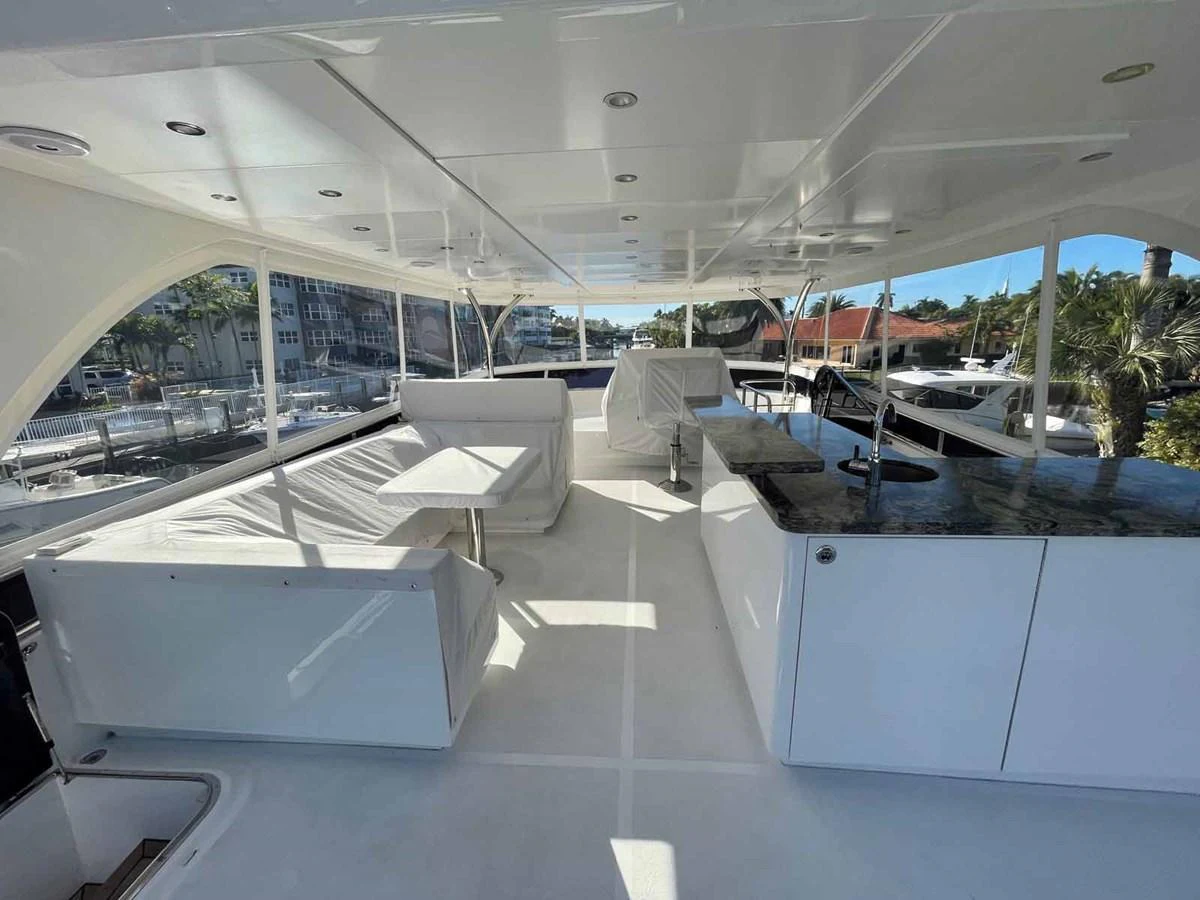 The flybridge offers a spacious and well-appointed area for relaxation and entertainment. aboard JOHNSON 83' FLYBRIDGE W/HYDRAULIC PLATFORM Yacht for Sale