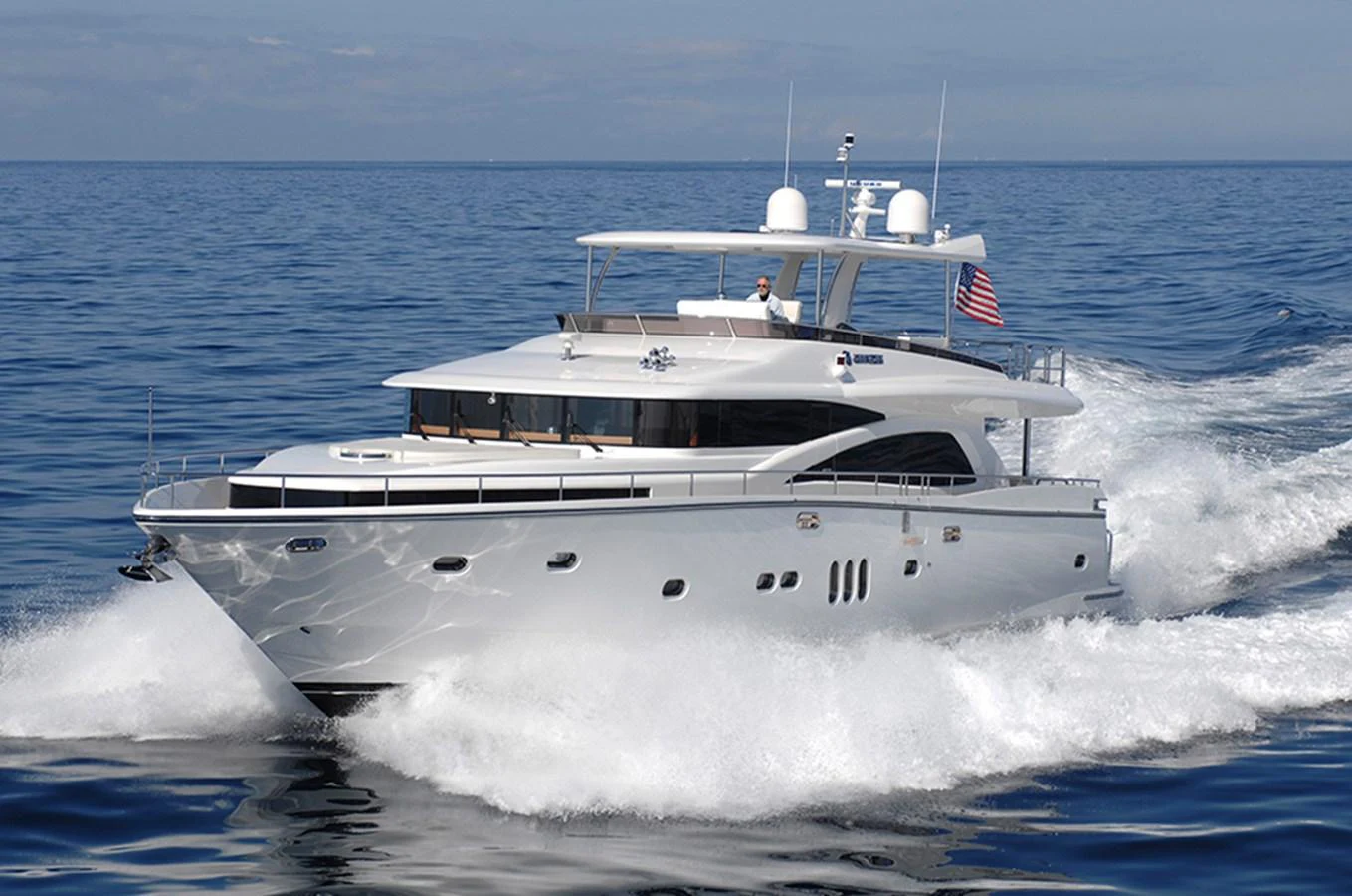 A sleek and modern yacht cruises swiftly on open waters, showcasing its elegant design and powerful performance. aboard JOHNSON 83' FLYBRIDGE W/HYDRAULIC PLATFORM Yacht for Sale