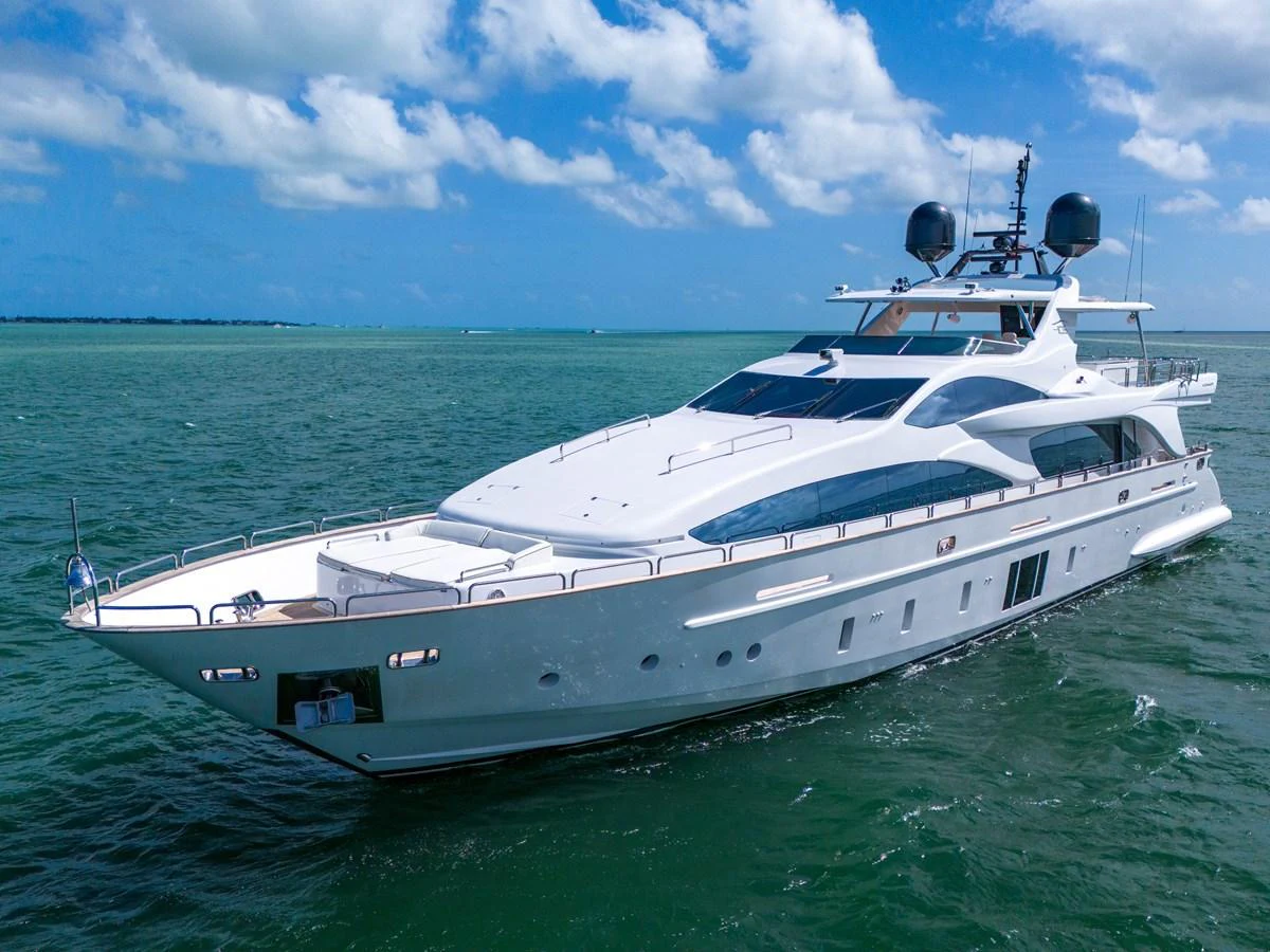 A sleek and modern yacht glides gracefully on the open water under a clear blue sky. aboard AZIMUT GRANDE 105 Yacht for Sale