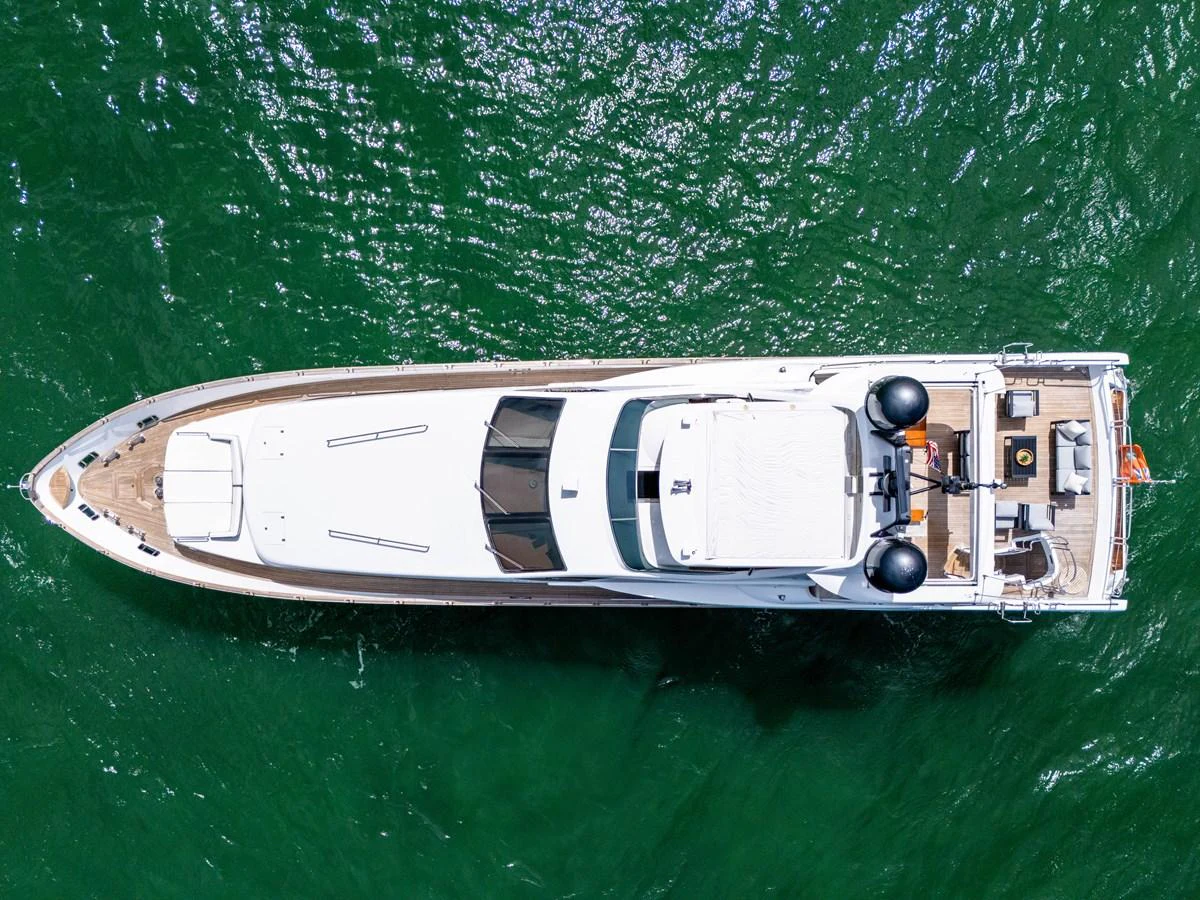 Aerial view of a sleek yacht cruising through vibrant green waters. aboard AZIMUT GRANDE 105 Yacht for Sale
