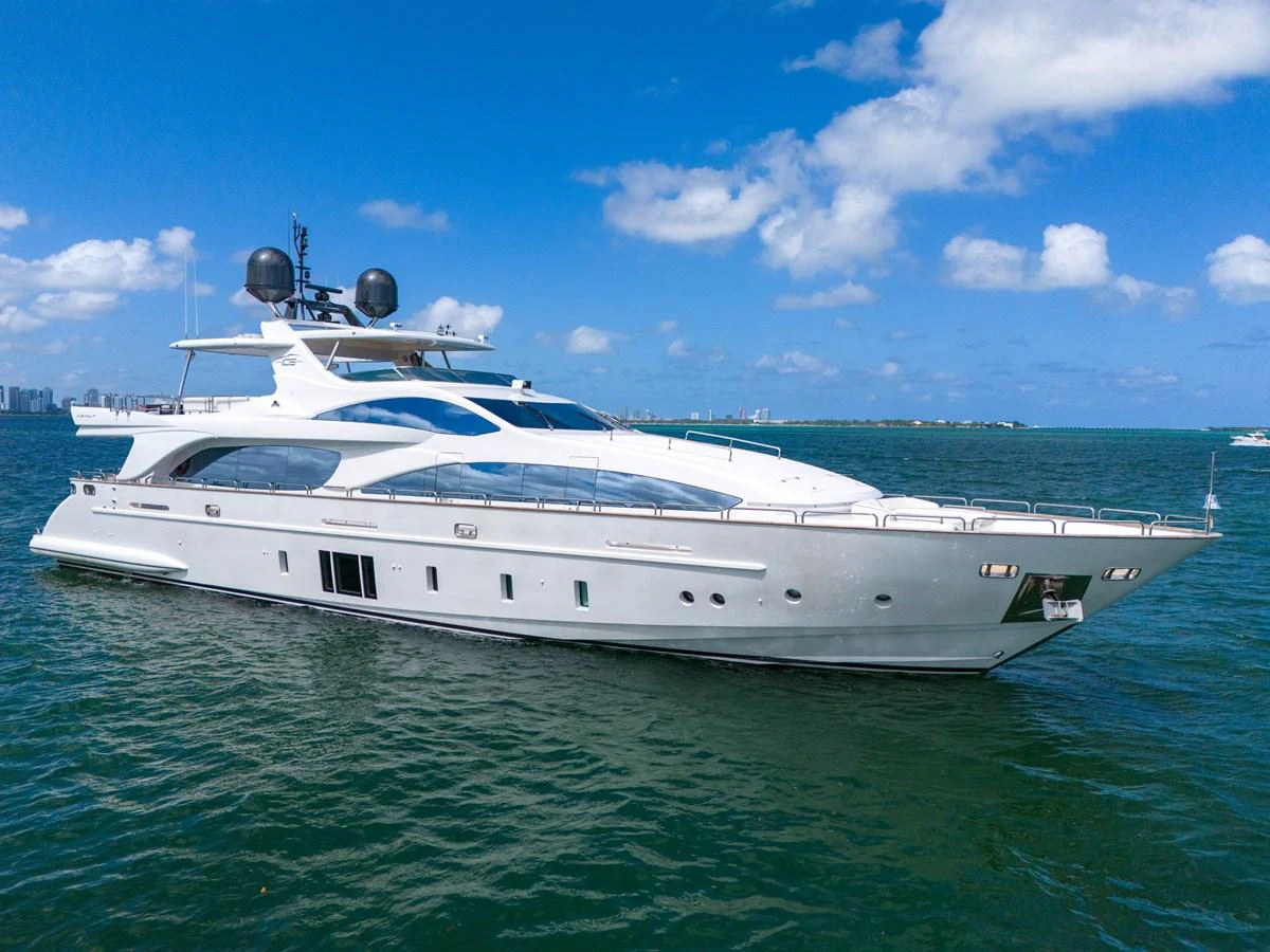 A sleek and modern yacht glides gracefully on the open water under a clear blue sky. aboard AZIMUT GRANDE 105 Yacht for Sale