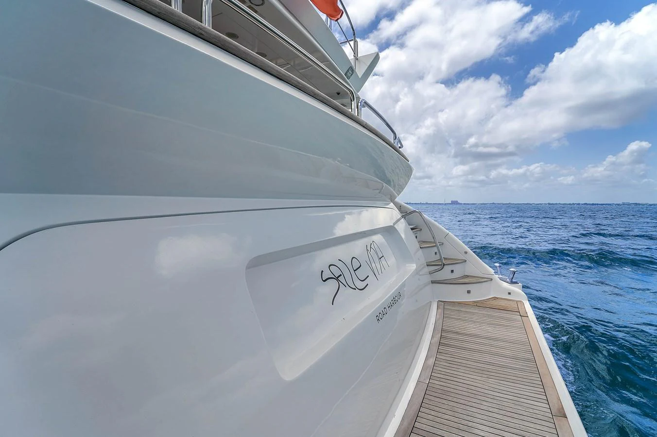 The yacht's sleek exterior is showcased against a backdrop of blue ocean and sky. aboard AZIMUT GRANDE 105 Yacht for Sale