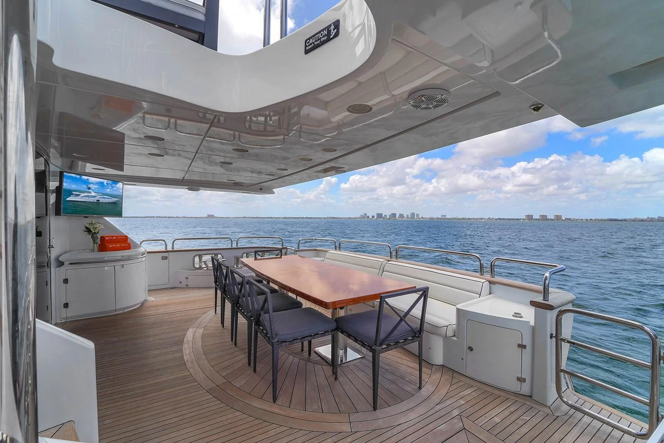 The aft deck offers a spacious dining area with a stunning view of the open sea. aboard AZIMUT GRANDE 105 Yacht for Sale