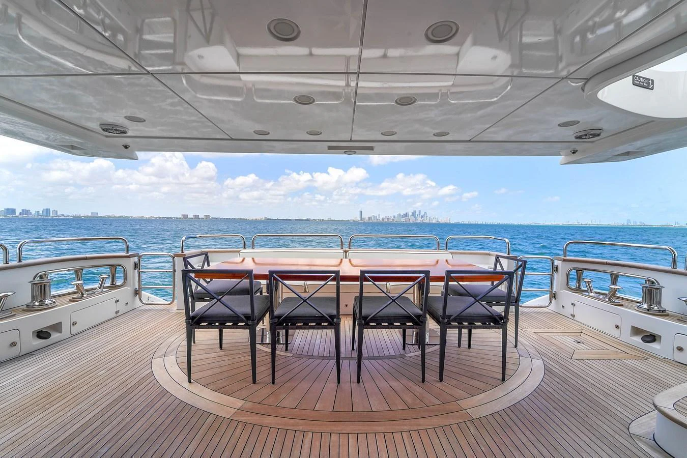 The aft deck features an elegant dining area with a stunning ocean view. aboard AZIMUT GRANDE 105 Yacht for Sale