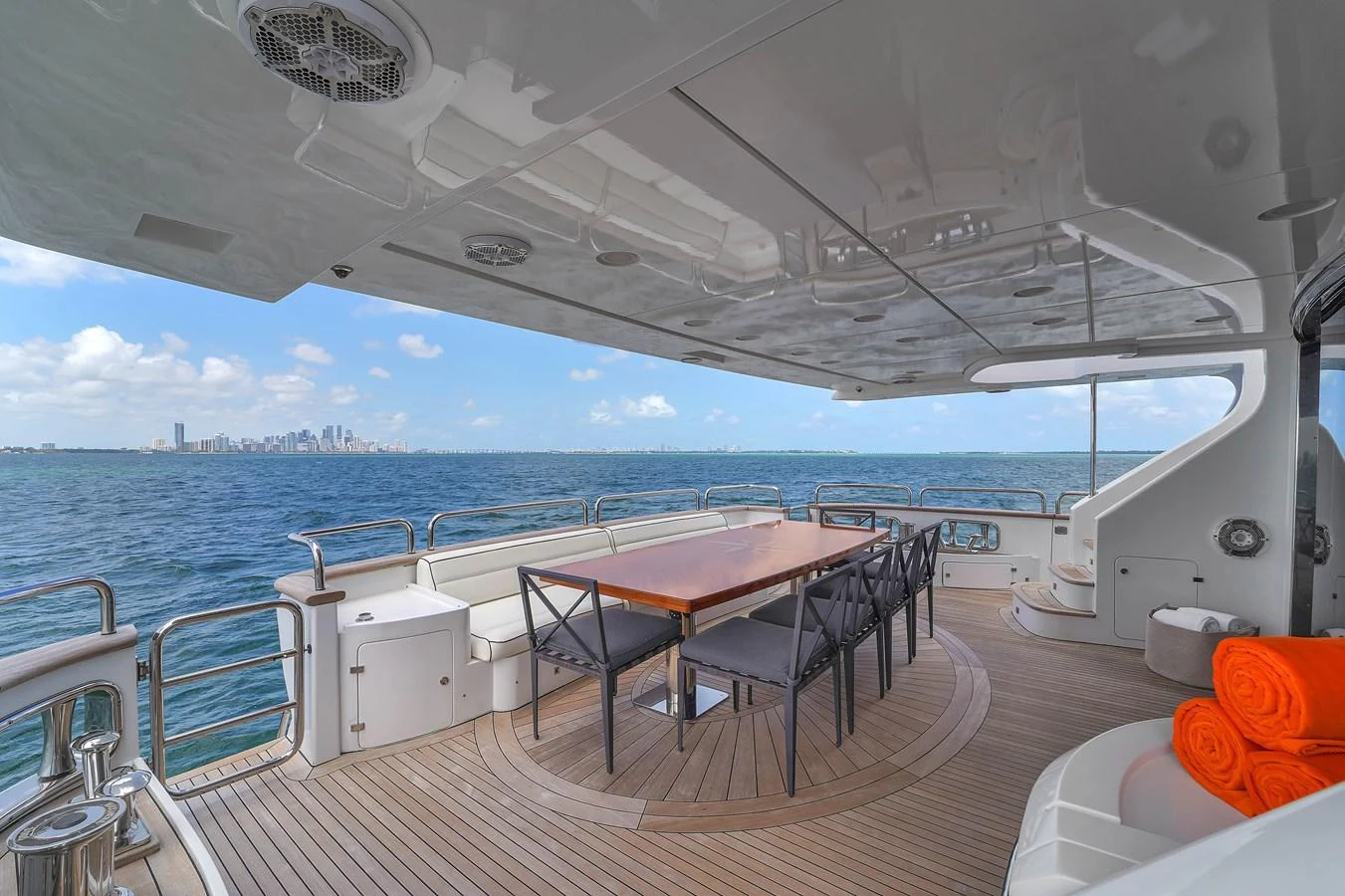 The aft deck offers a spacious and elegant dining area with stunning ocean views. aboard AZIMUT GRANDE 105 Yacht for Sale