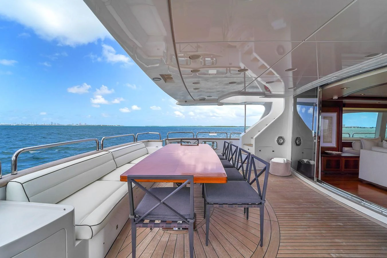 The aft deck features a spacious dining area with comfortable seating and stunning ocean views. aboard AZIMUT GRANDE 105 Yacht for Sale