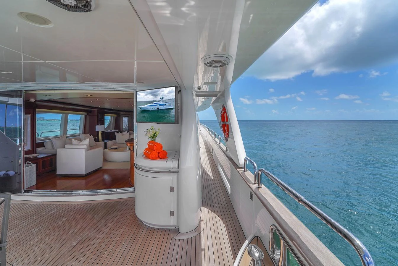 The side deck offers a seamless transition between the interior lounge and the open sea, with luxurious touches and panoramic views. aboard AZIMUT GRANDE 105 Yacht for Sale
