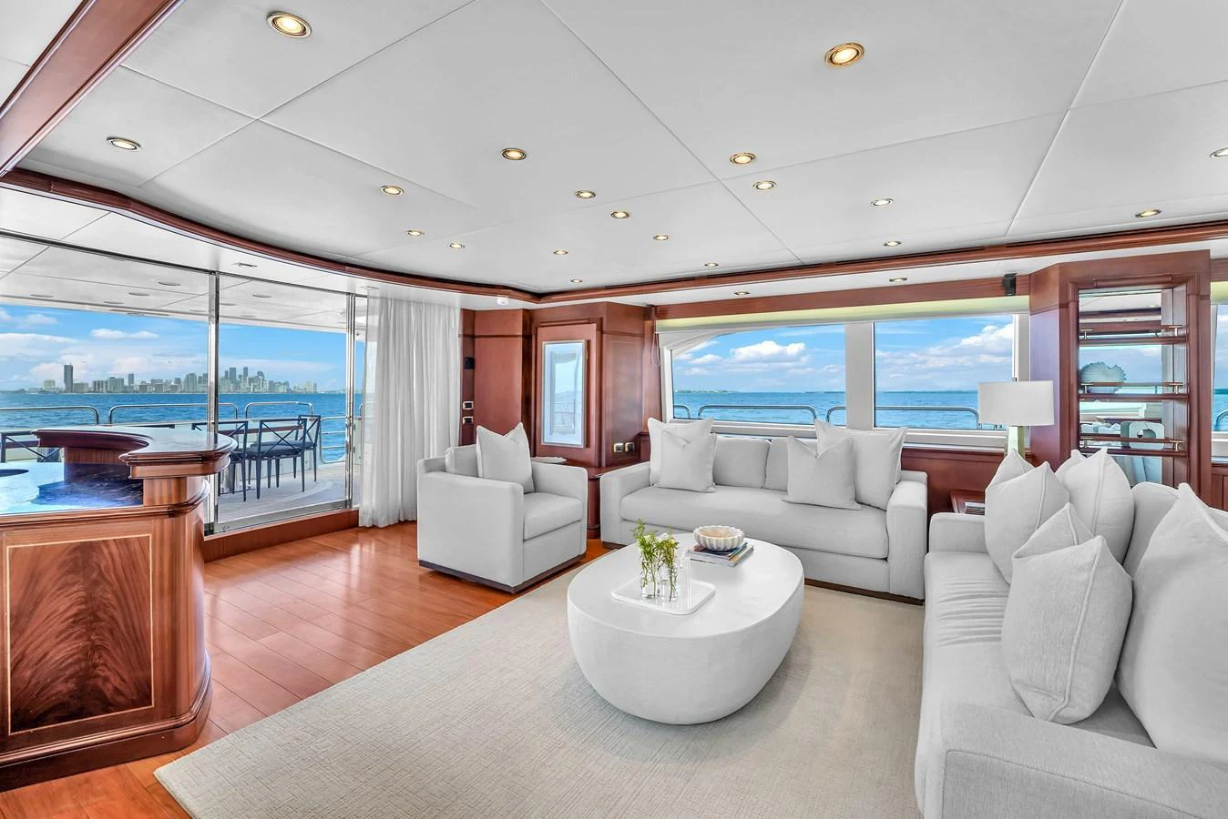 The salon features plush seating, a modern coffee table, and expansive windows offering stunning ocean views. aboard AZIMUT GRANDE 105 Yacht for Sale