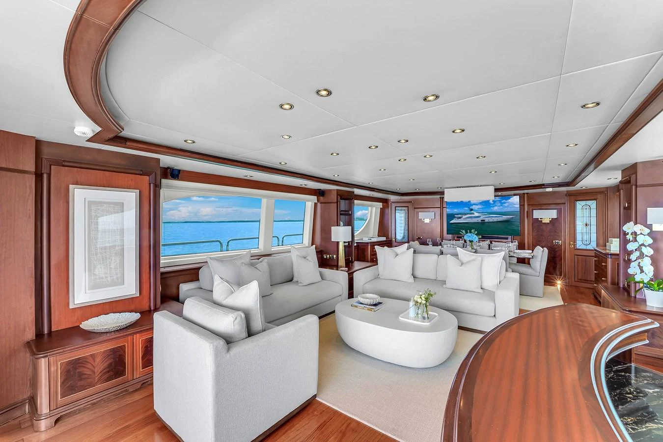 The salon features luxurious seating with panoramic ocean views through large windows. aboard AZIMUT GRANDE 105 Yacht for Sale