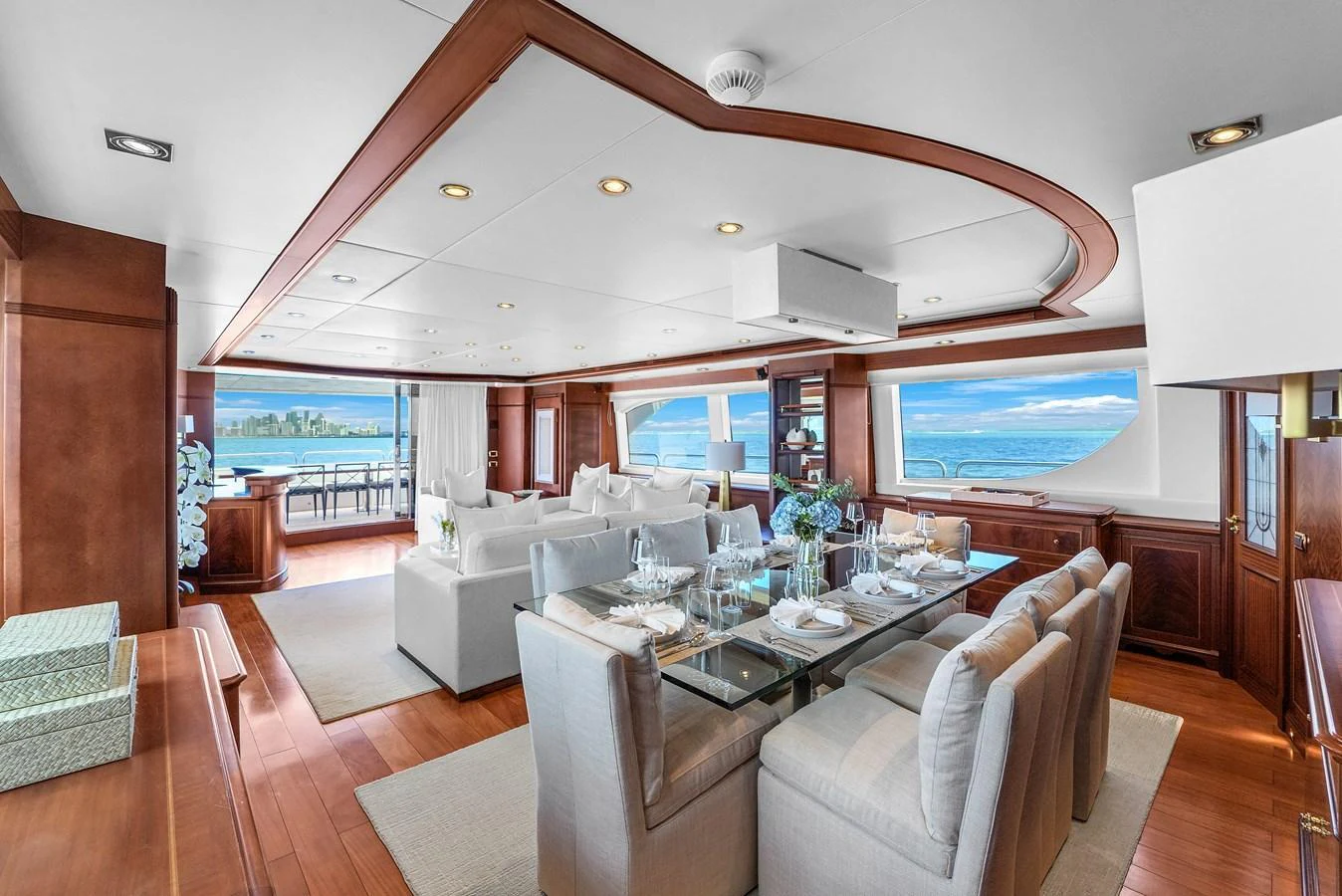 The salon features a spacious seating area with panoramic ocean views and elegant dining space. aboard AZIMUT GRANDE 105 Yacht for Sale