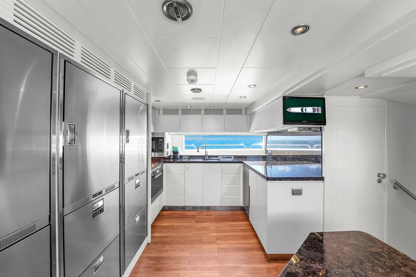 The galley features modern stainless steel appliances and a sleek design with ample counter space. aboard AZIMUT GRANDE 105 Yacht for Sale