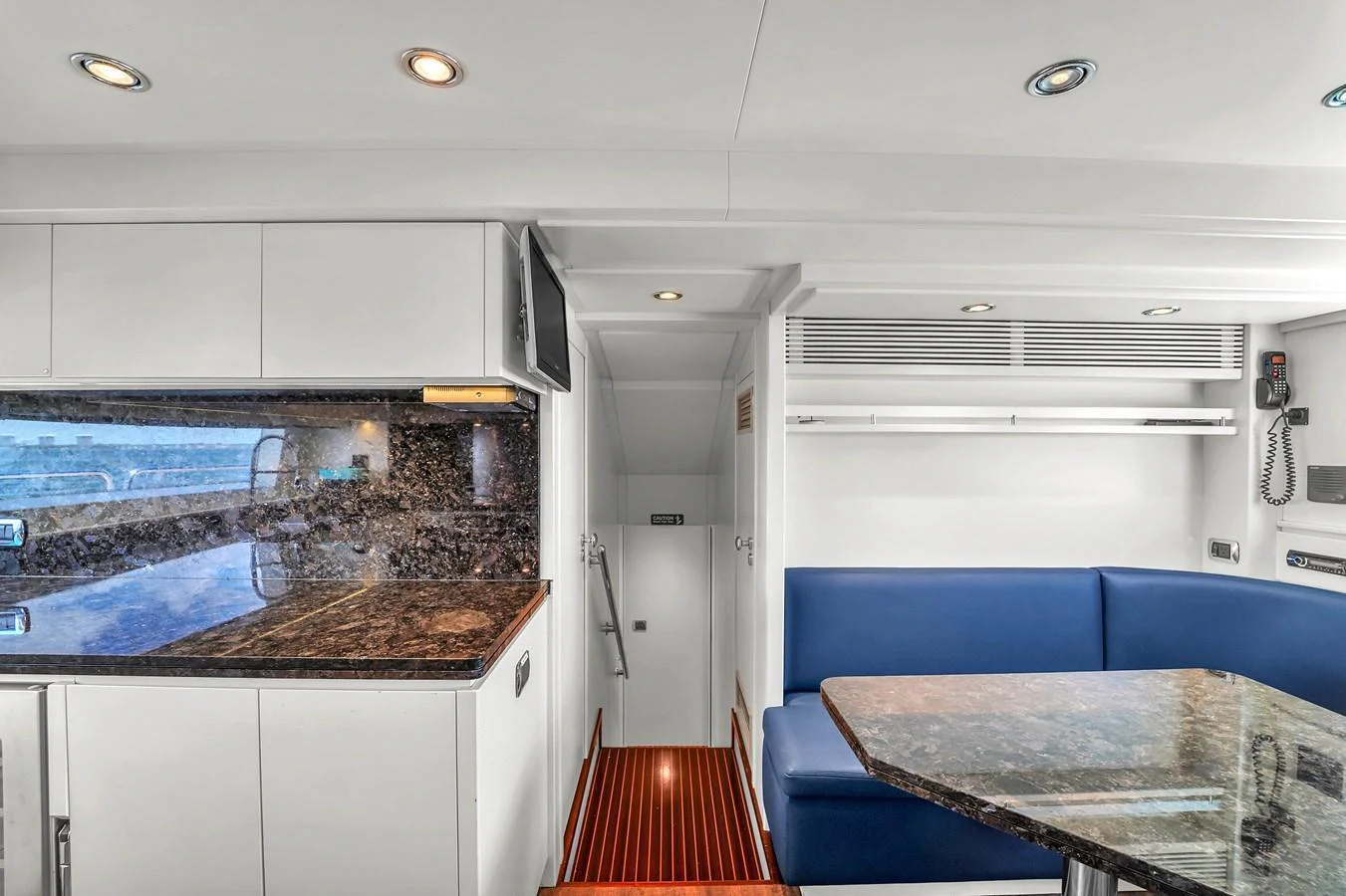 The yacht's galley features a sleek design with modern appliances and a cozy dining area. aboard AZIMUT GRANDE 105 Yacht for Sale