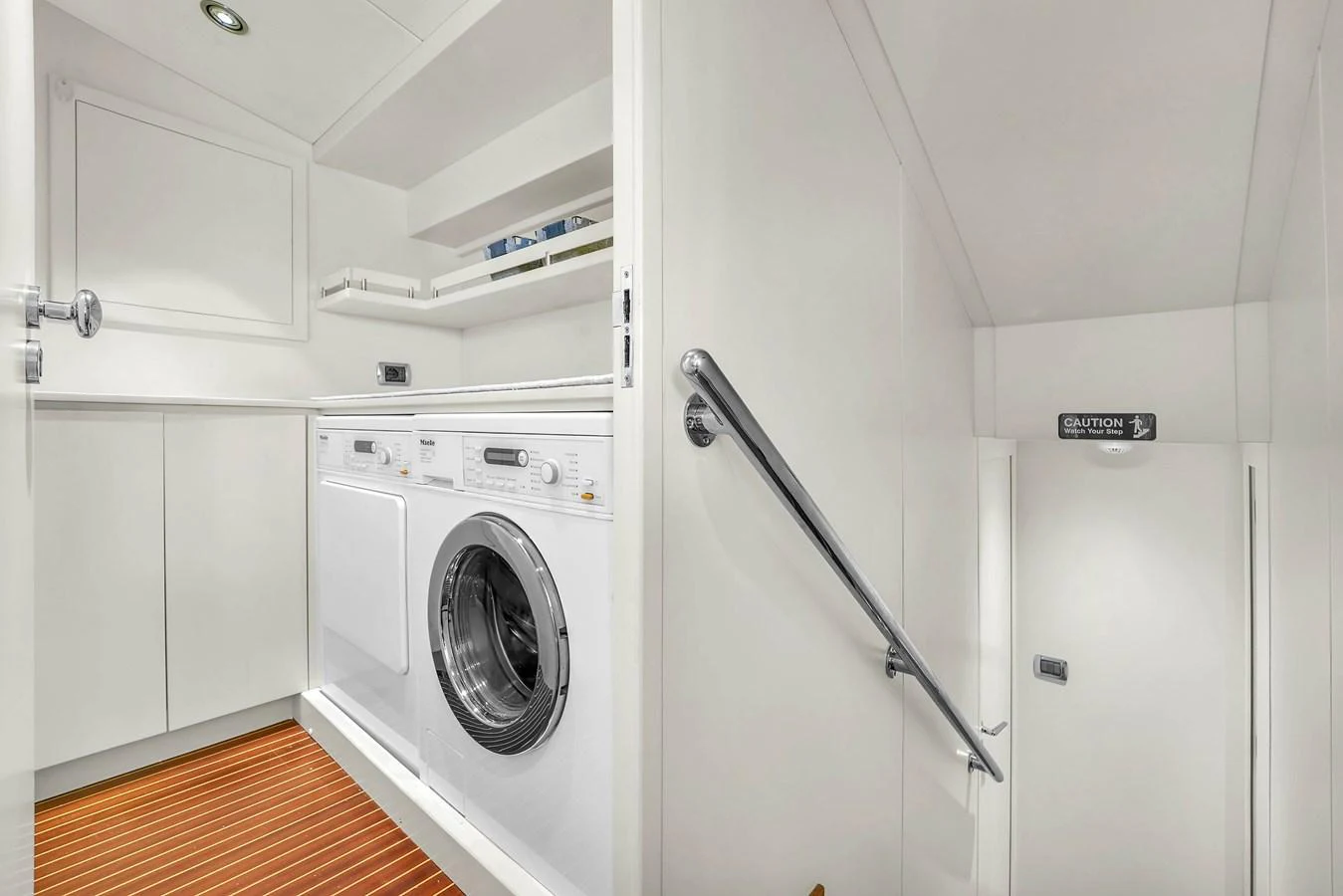 The yacht features a pristine laundry room with modern appliances and ample storage space. aboard AZIMUT GRANDE 105 Yacht for Sale