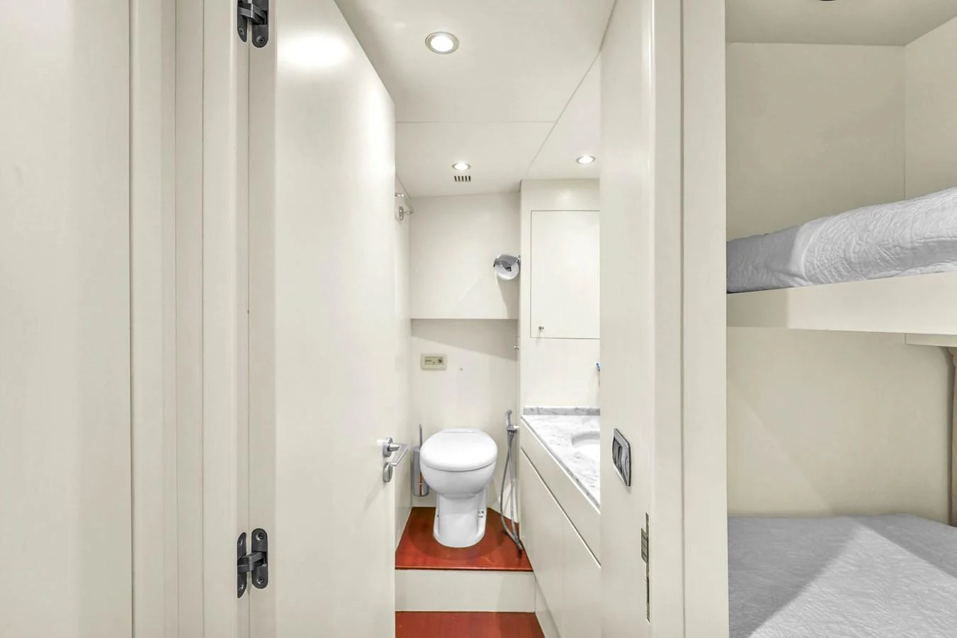 The crew quarters feature a compact and functional design with a bunk bed and an en-suite bathroom. aboard AZIMUT GRANDE 105 Yacht for Sale
