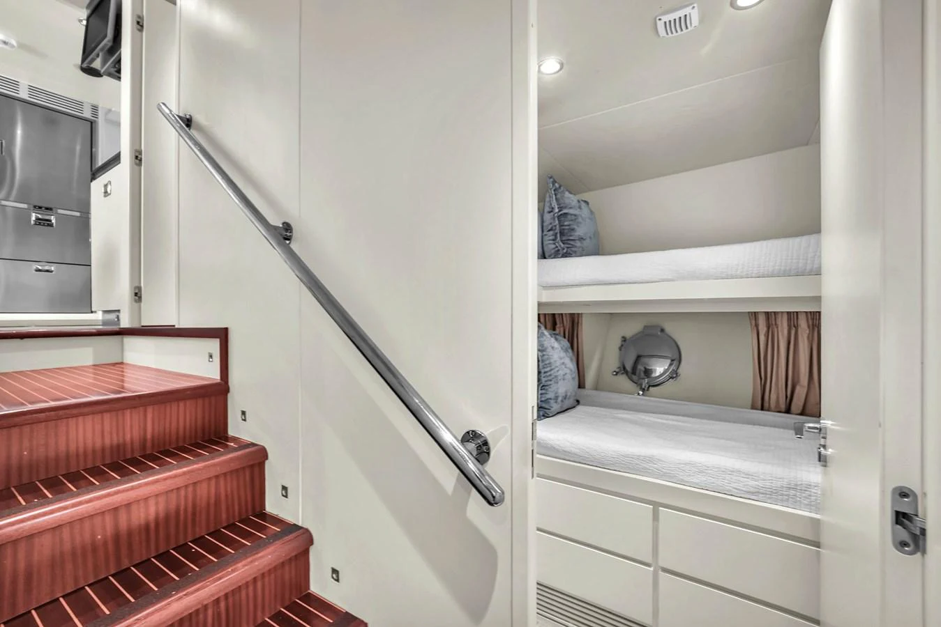 The crew quarters feature practical bunk beds and a sleek staircase. aboard AZIMUT GRANDE 105 Yacht for Sale