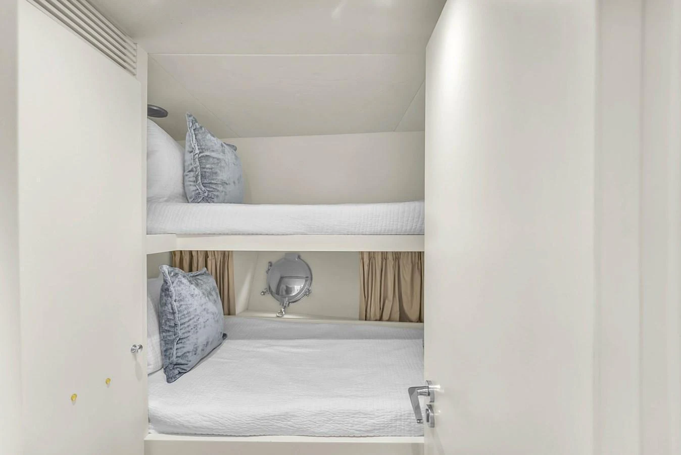 A cozy bunk cabin featuring two neatly made beds with plush pillows. aboard AZIMUT GRANDE 105 Yacht for Sale