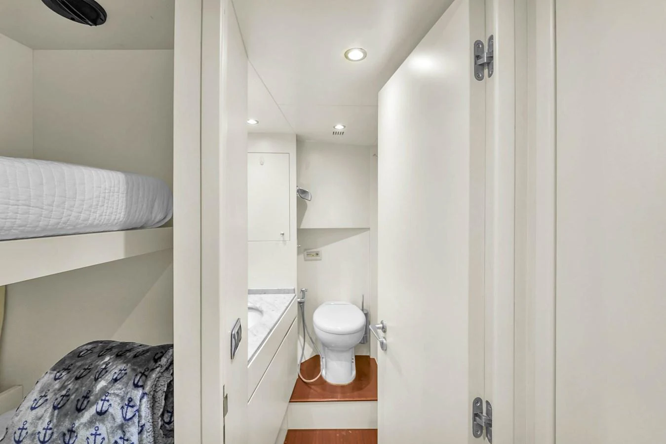 The yacht's bathroom features a clean, minimalist design with white fixtures and ample lighting. aboard AZIMUT GRANDE 105 Yacht for Sale