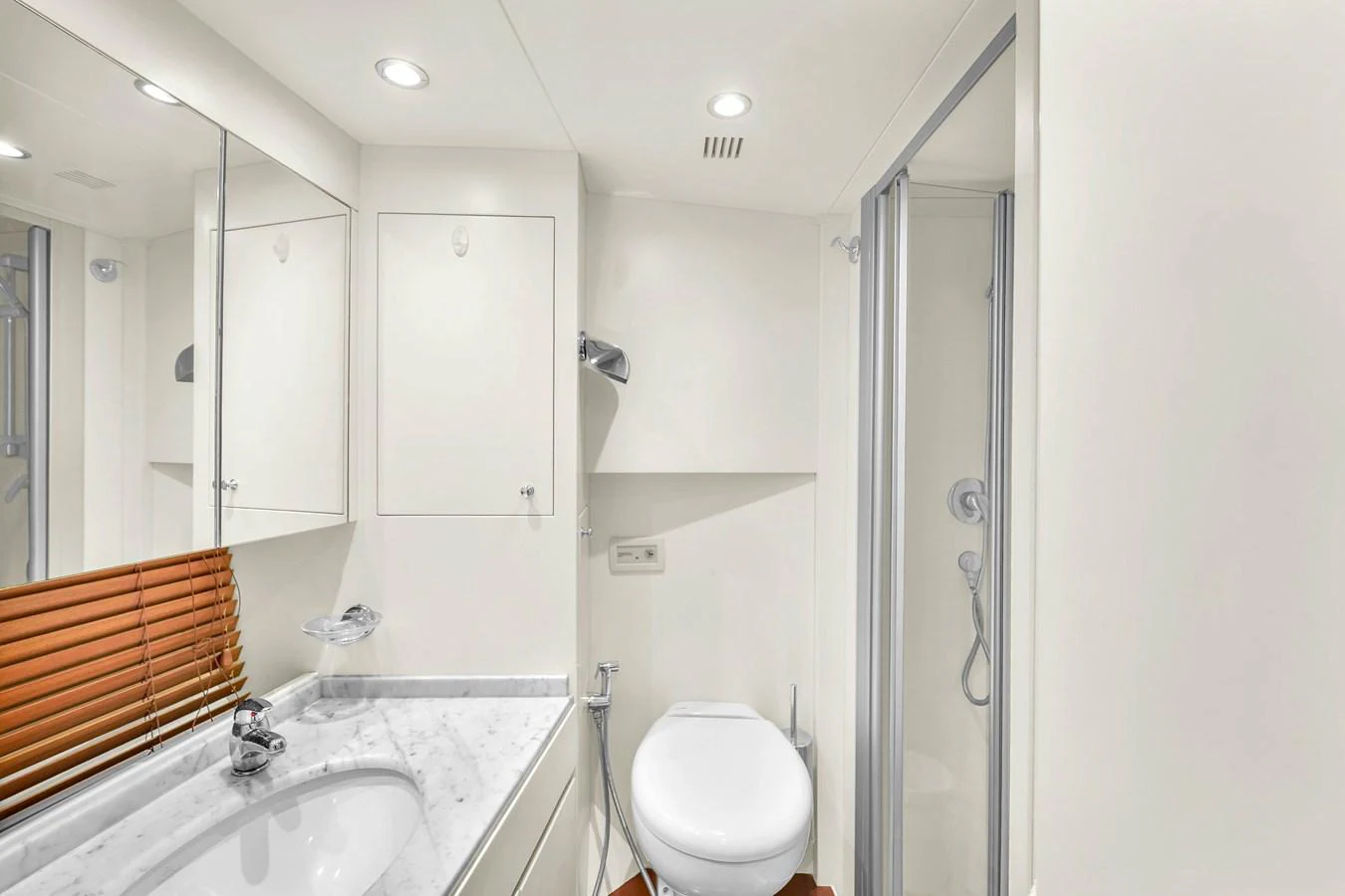 The yacht's bathroom features a sleek design with a marble countertop and a glass-enclosed shower. aboard AZIMUT GRANDE 105 Yacht for Sale