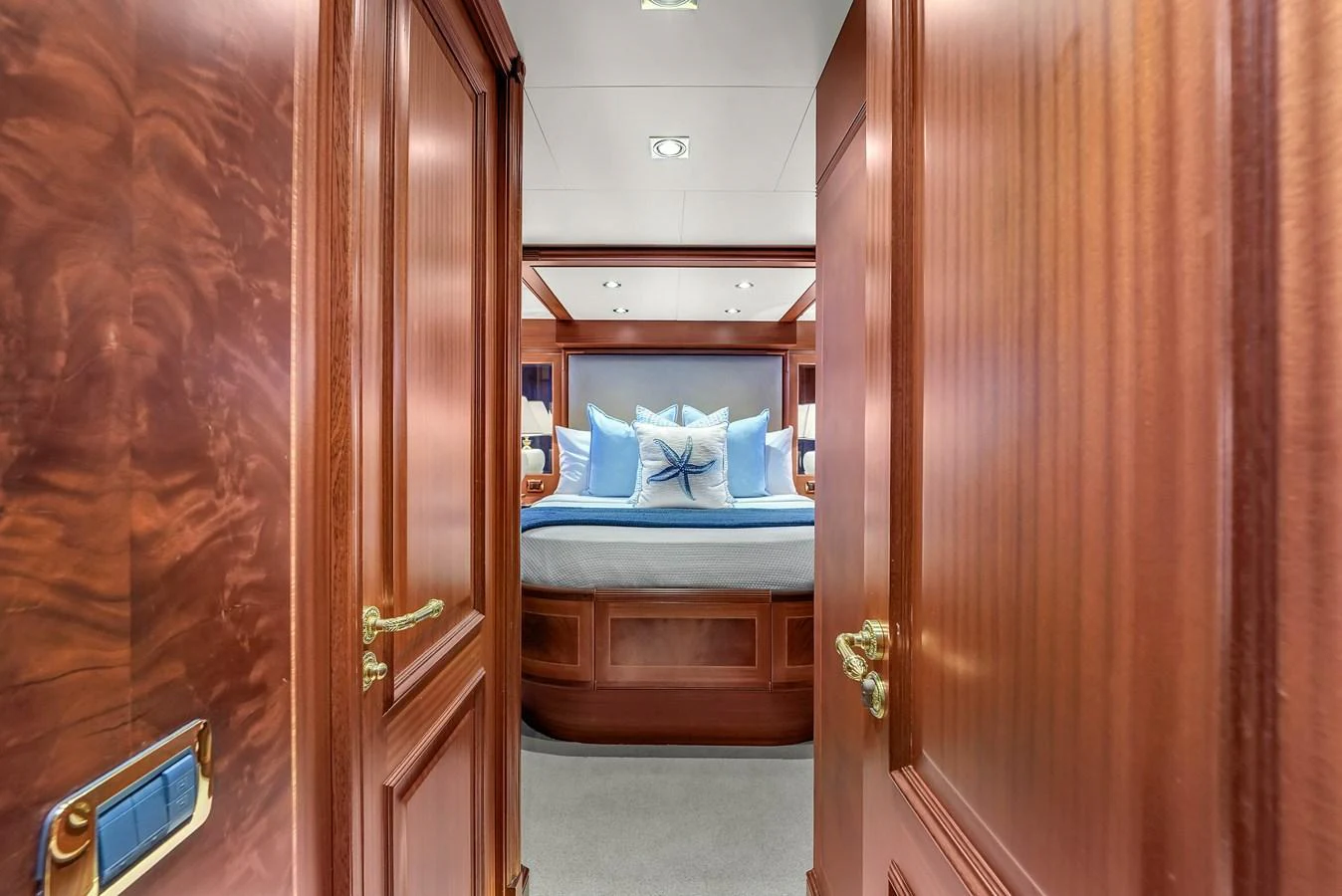 A luxurious stateroom with elegant wood paneling and plush bedding. aboard AZIMUT GRANDE 105 Yacht for Sale
