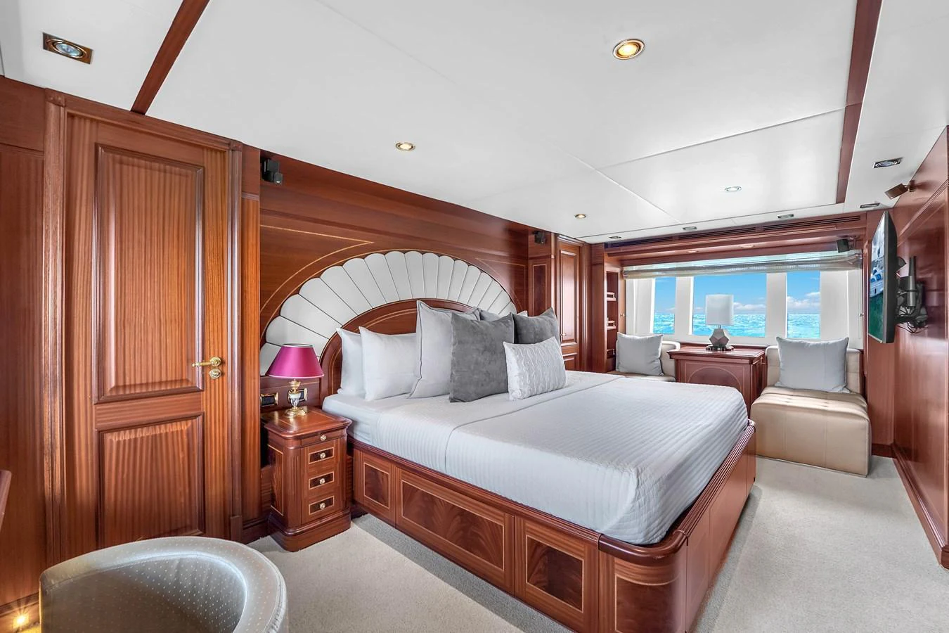 The master stateroom features luxurious wood paneling and expansive windows with ocean views. aboard AZIMUT GRANDE 105 Yacht for Sale