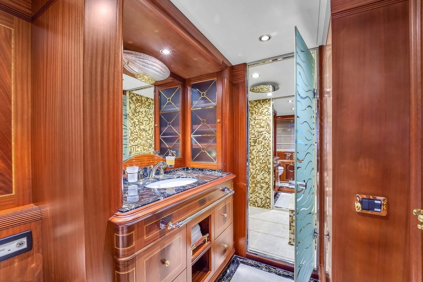 The yacht's bathroom features luxurious wooden cabinetry and elegant fixtures. aboard AZIMUT GRANDE 105 Yacht for Sale