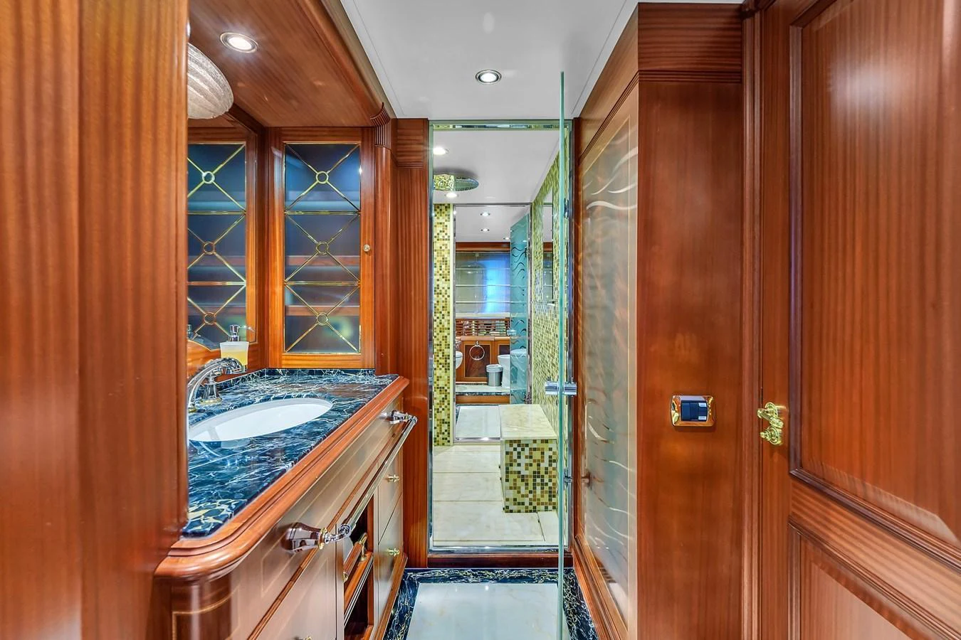 The yacht's bathroom features luxurious wood paneling and elegant marble countertops. aboard AZIMUT GRANDE 105 Yacht for Sale