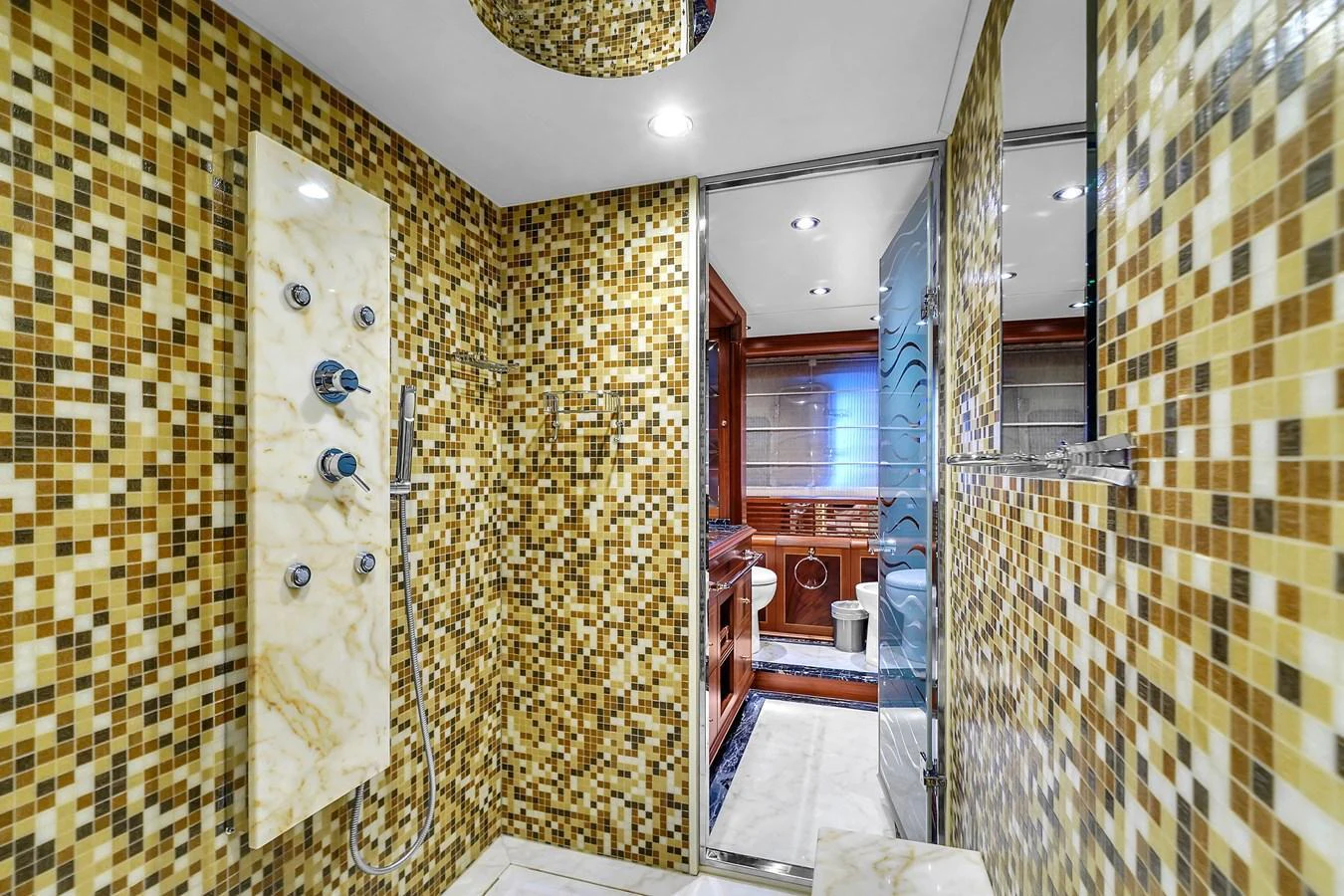The yacht's bathroom features a luxurious mosaic tile design with modern fixtures. aboard AZIMUT GRANDE 105 Yacht for Sale