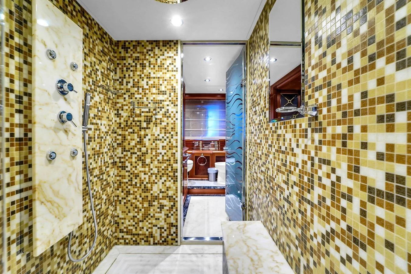 The yacht's bathroom features a luxurious shower area with intricate mosaic tiles and modern fixtures. aboard AZIMUT GRANDE 105 Yacht for Sale