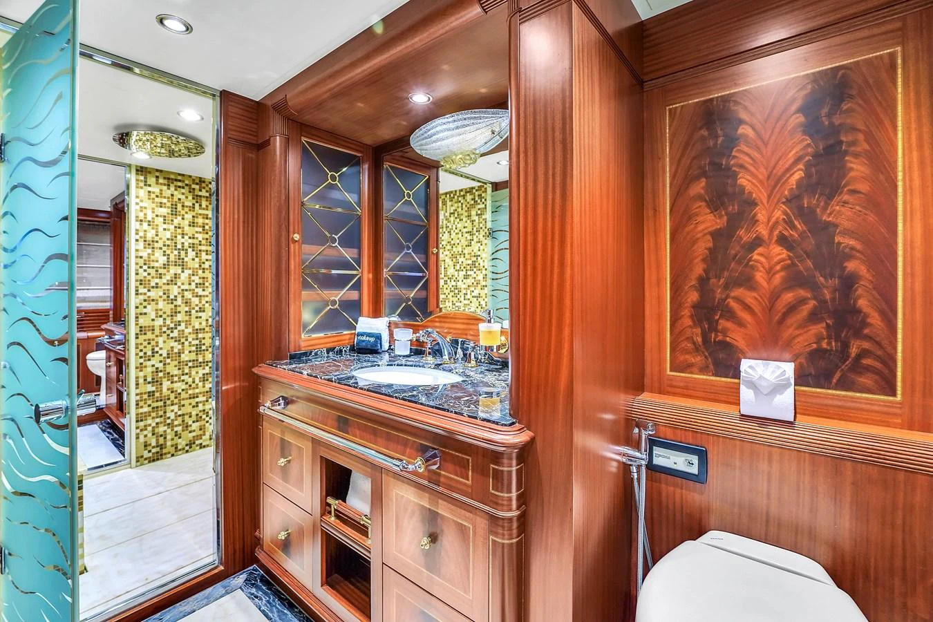 The yacht's bathroom features luxurious wood paneling, a marble countertop, and intricate glass detailing. aboard AZIMUT GRANDE 105 Yacht for Sale