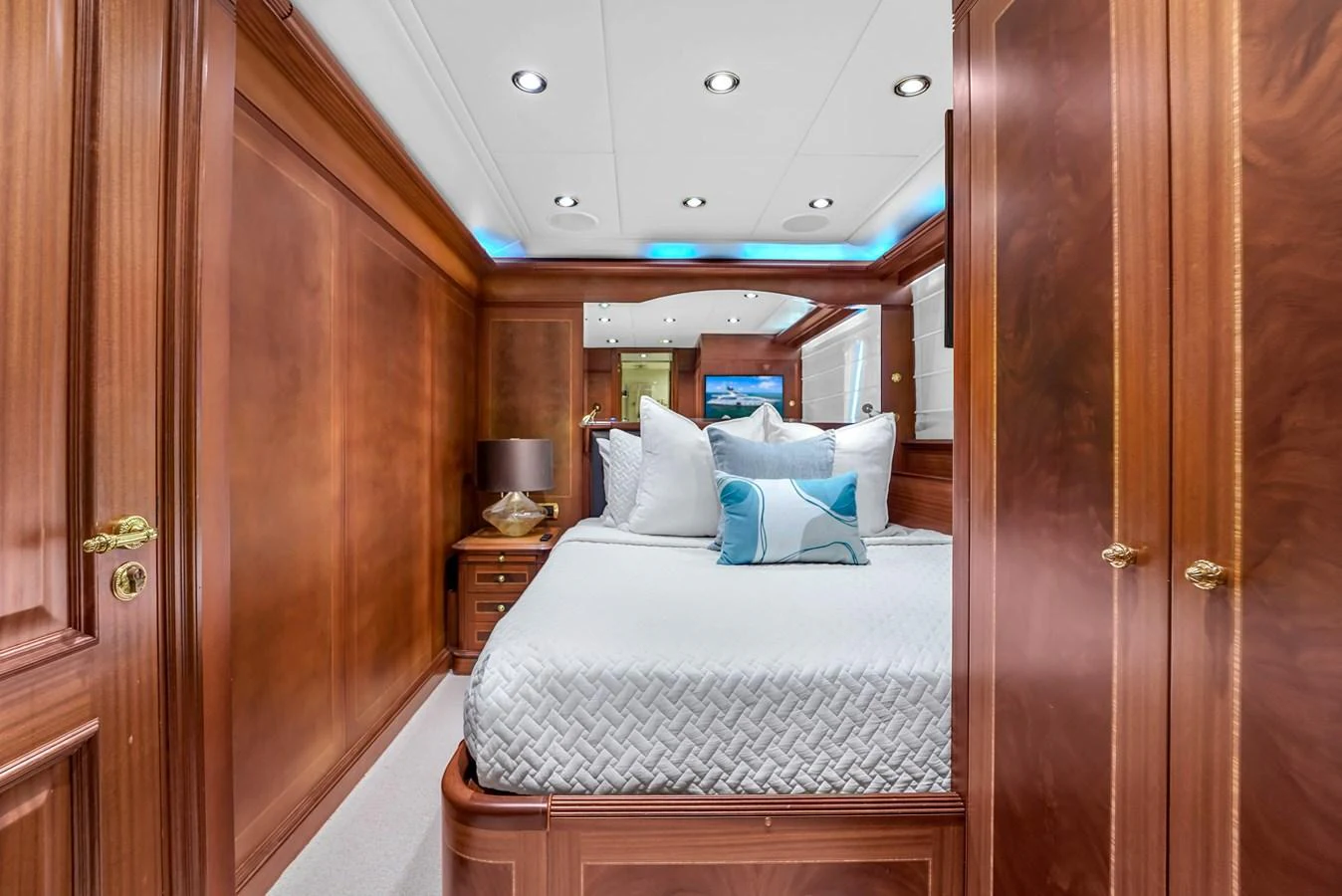 The stateroom features luxurious wood paneling and a comfortable bed with plush pillows. aboard AZIMUT GRANDE 105 Yacht for Sale