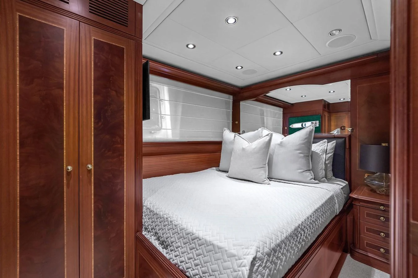 A cozy stateroom with a plush bed and elegant wooden cabinetry. aboard AZIMUT GRANDE 105 Yacht for Sale