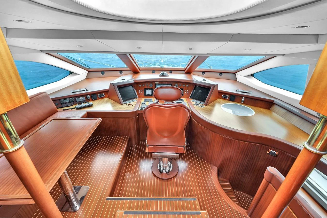 The helm station features a sophisticated control area with panoramic views of the sea. aboard AZIMUT GRANDE 105 Yacht for Sale