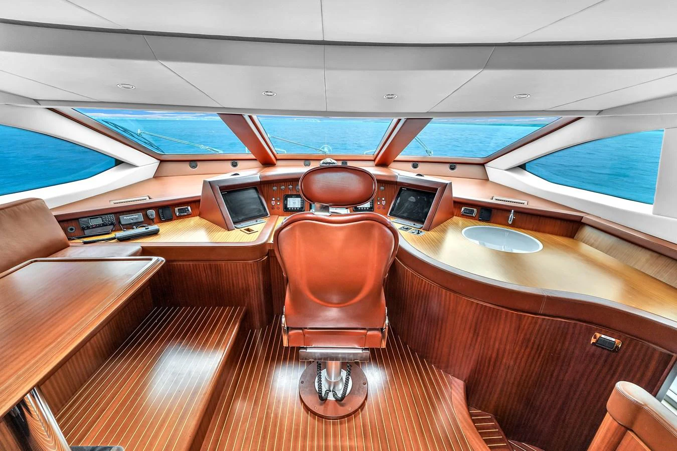 The helm station features a sleek design with state-of-the-art navigation equipment and panoramic windows offering stunning ocean views. aboard AZIMUT GRANDE 105 Yacht for Sale